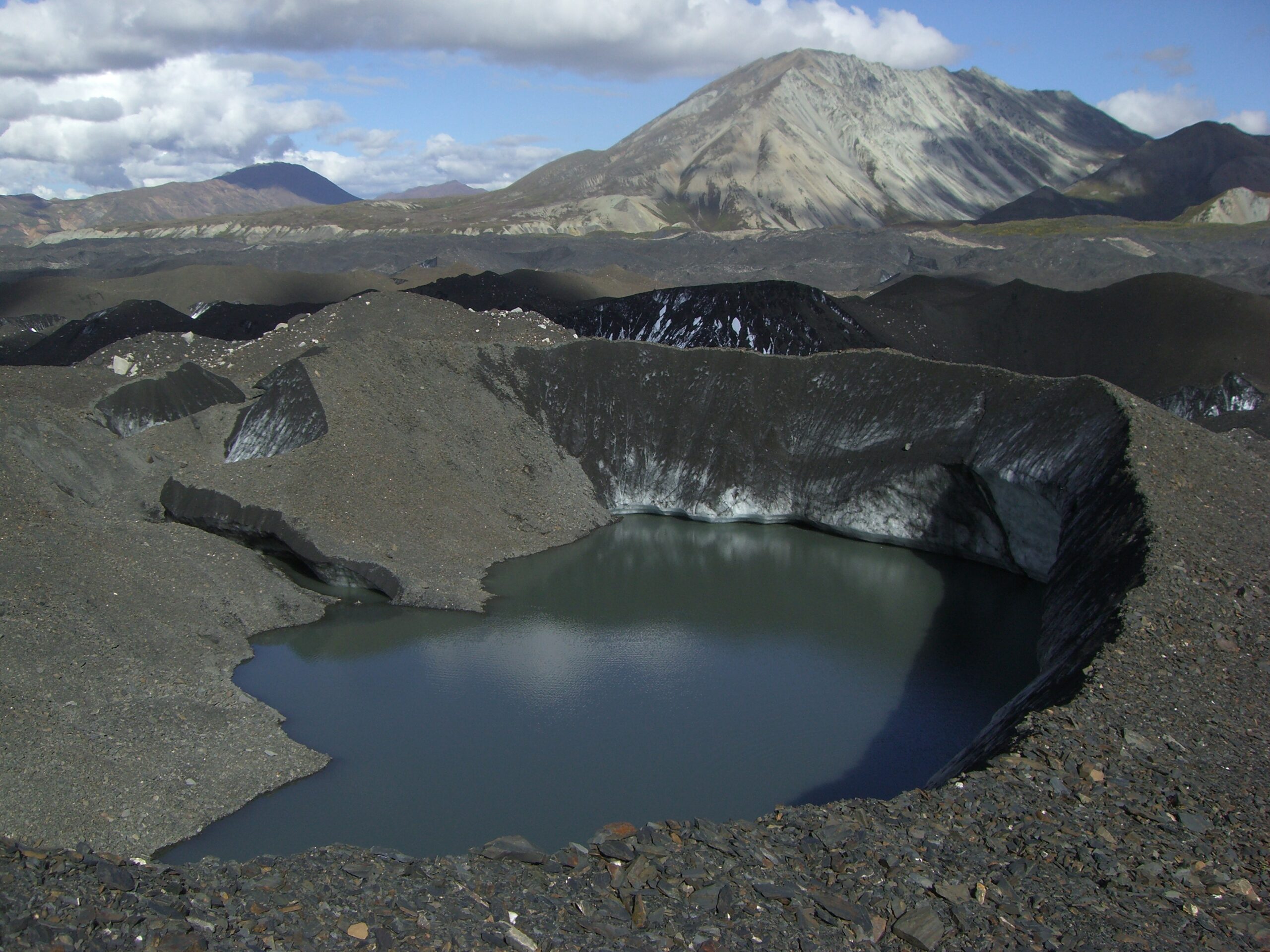 Melted ice sites in a rock bed on Muldrow Glacier.