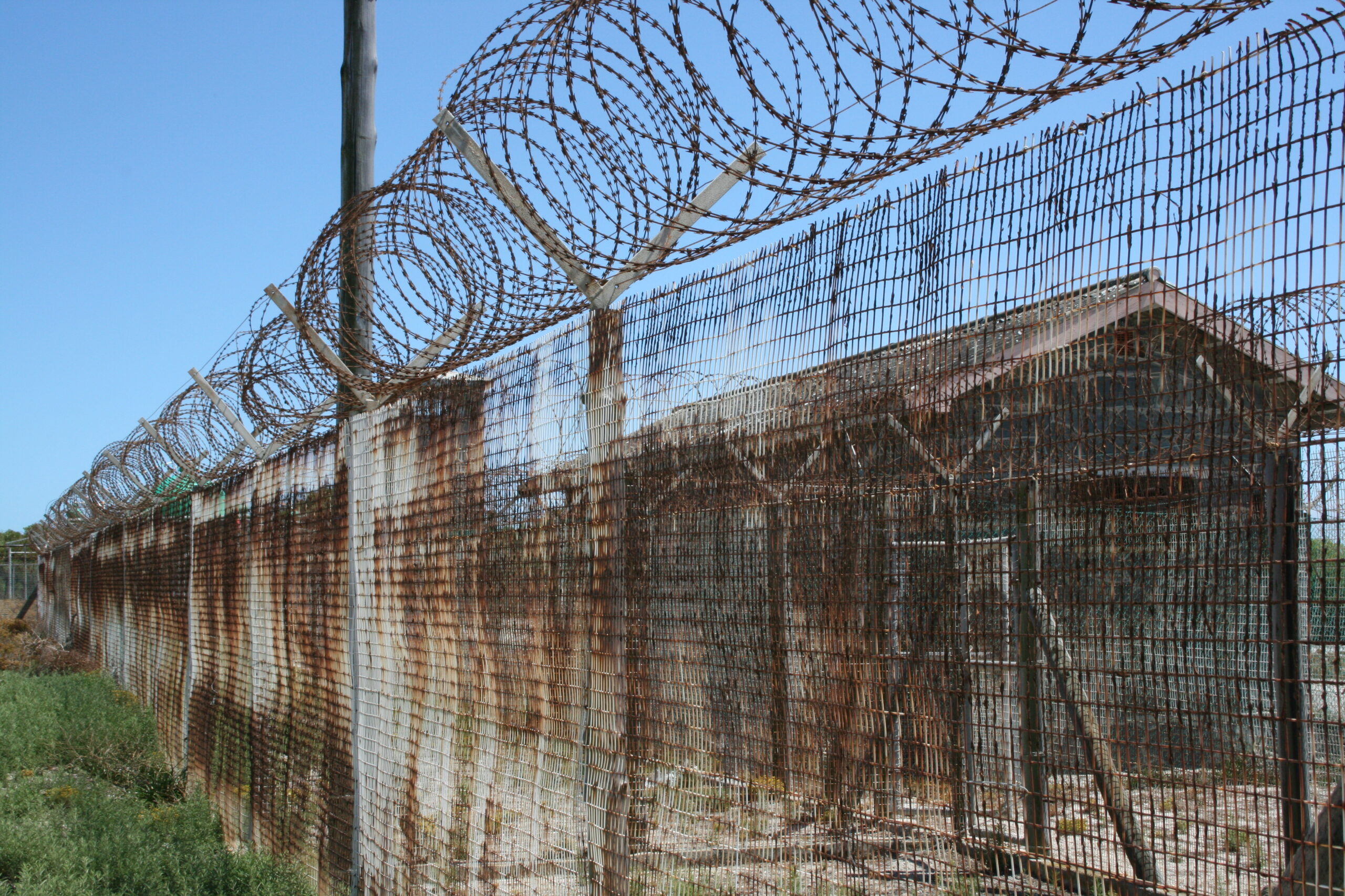 A barbed wire fence guards the prison on Robben Island near Cape Town, South Africa.