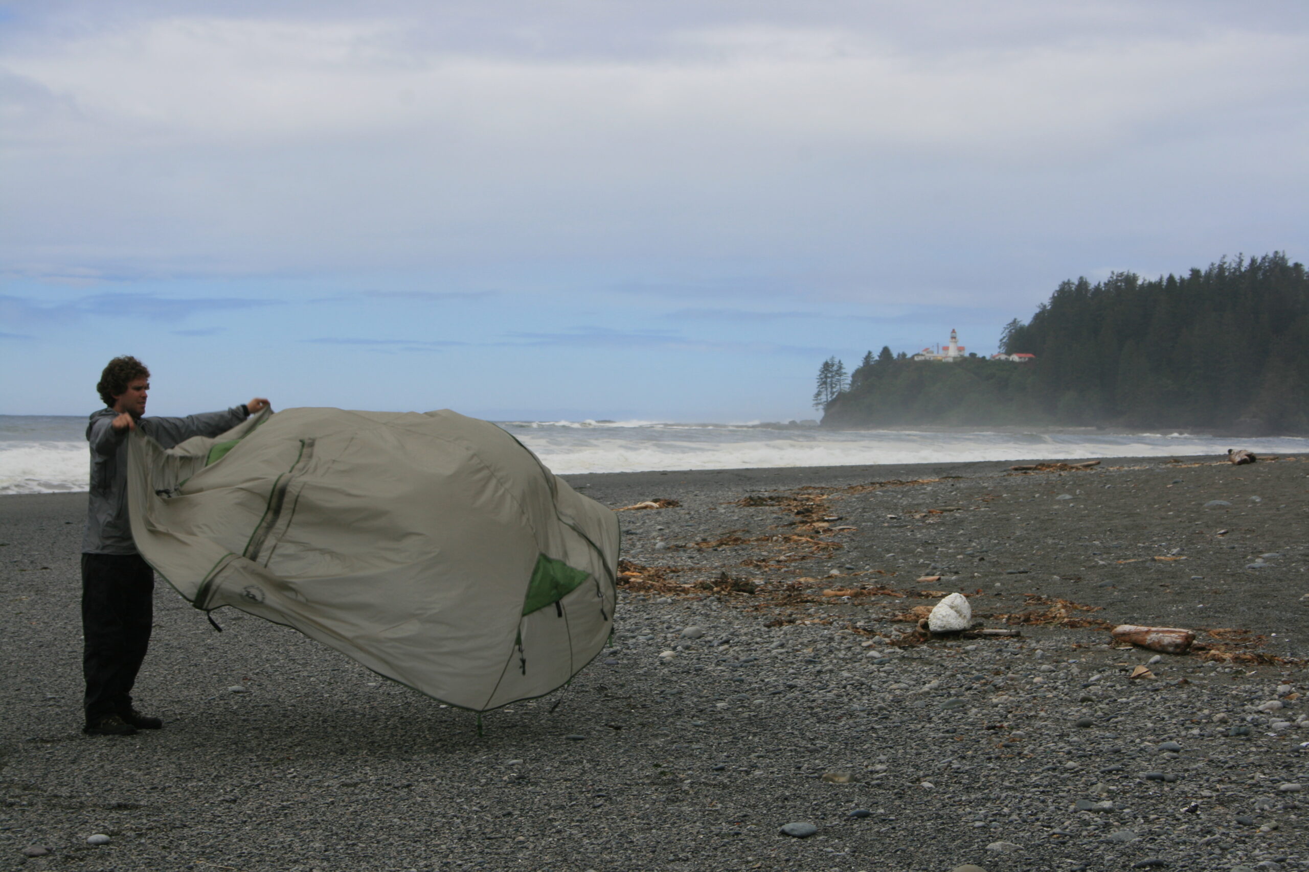 My brother Brian folds a wet tent in the morning after our hike's worst day