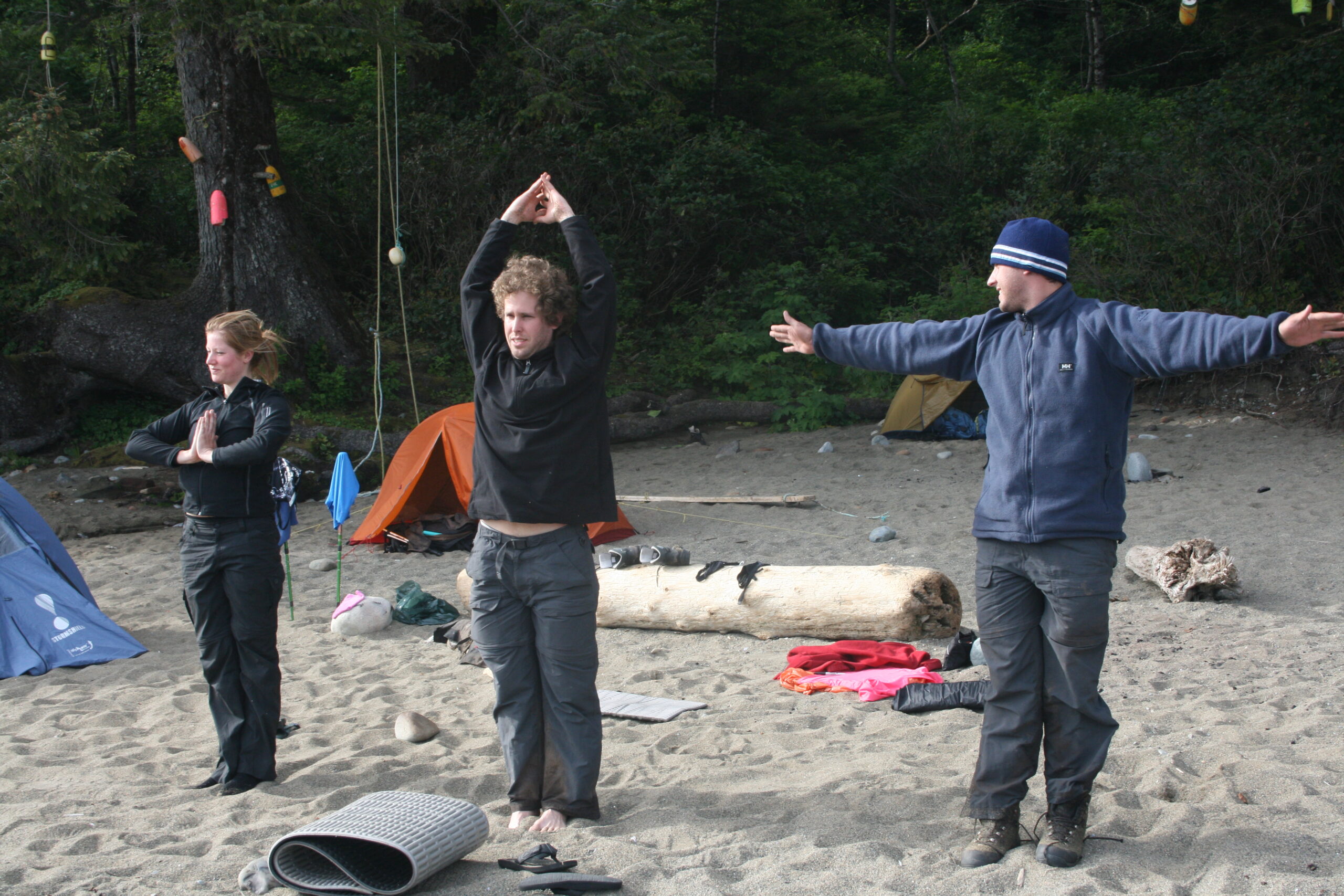 A strangely uncoordinated beach yoga session after a long hike