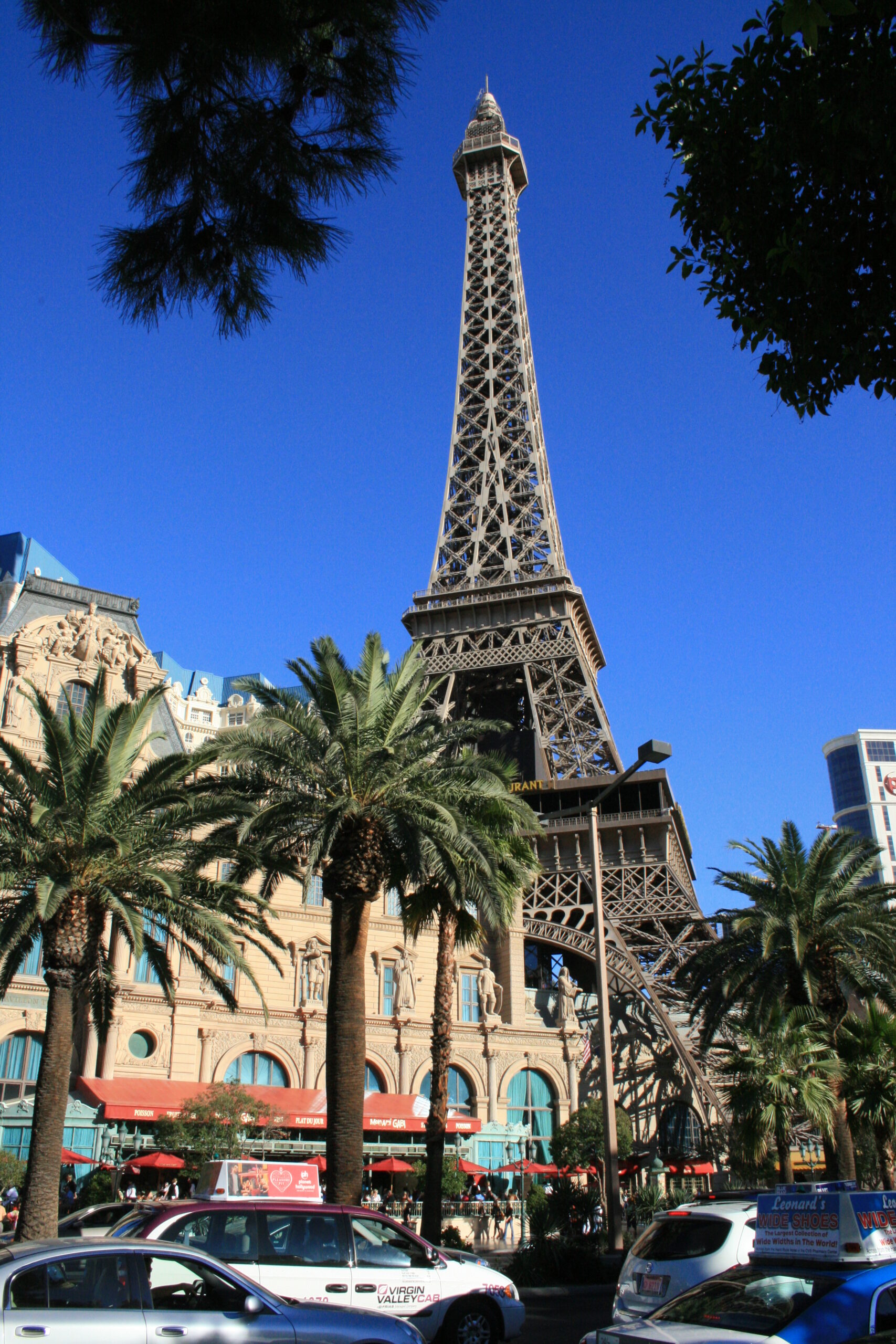 A fake Eiffel Tower in front of palm trees at the Paris Casino in Las Vegas.