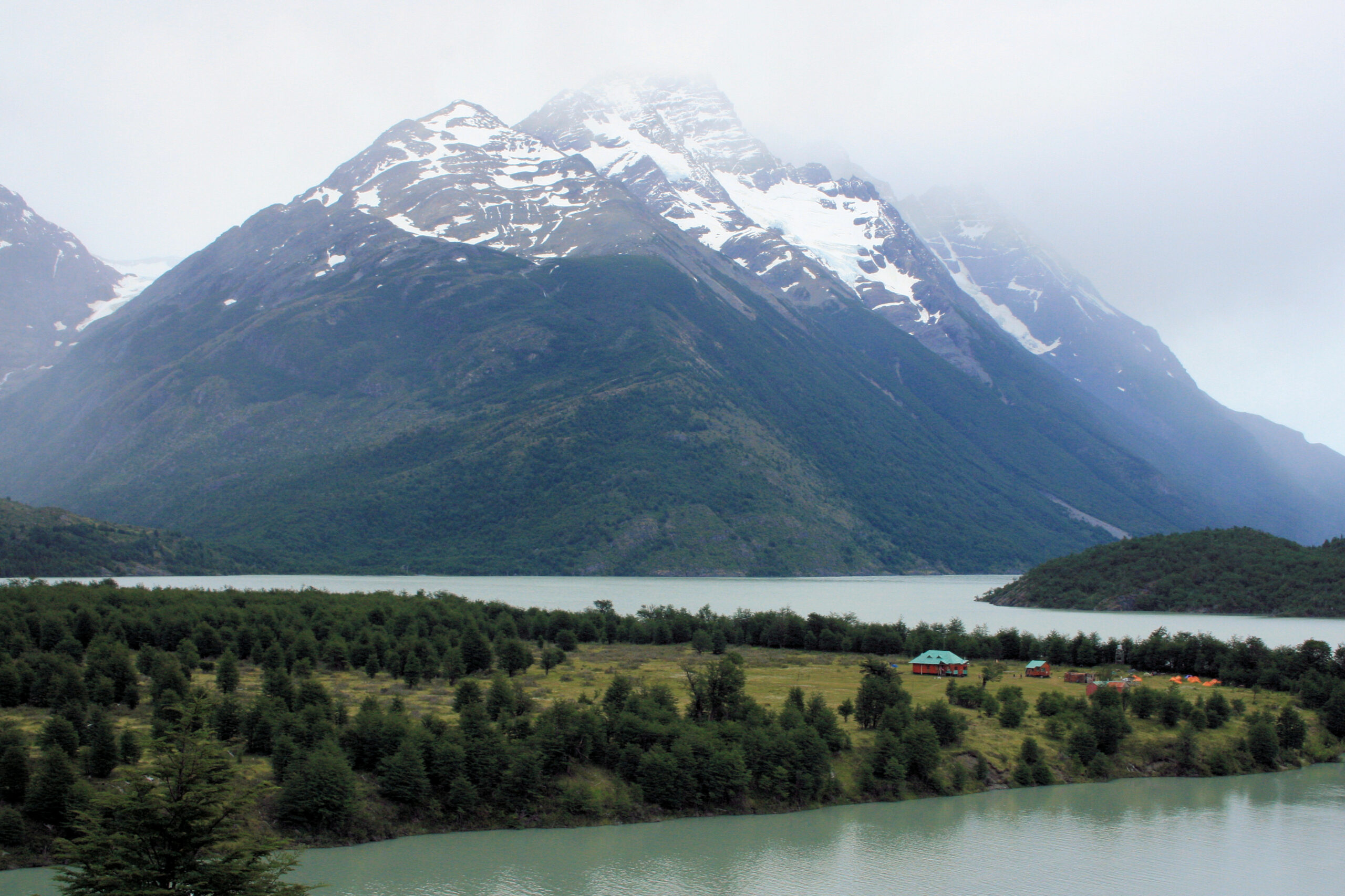 Mountains shrouded in fog behind Refugio Lago Paine in Chilean Patagonia&#039;s Torres del Paine National Park.