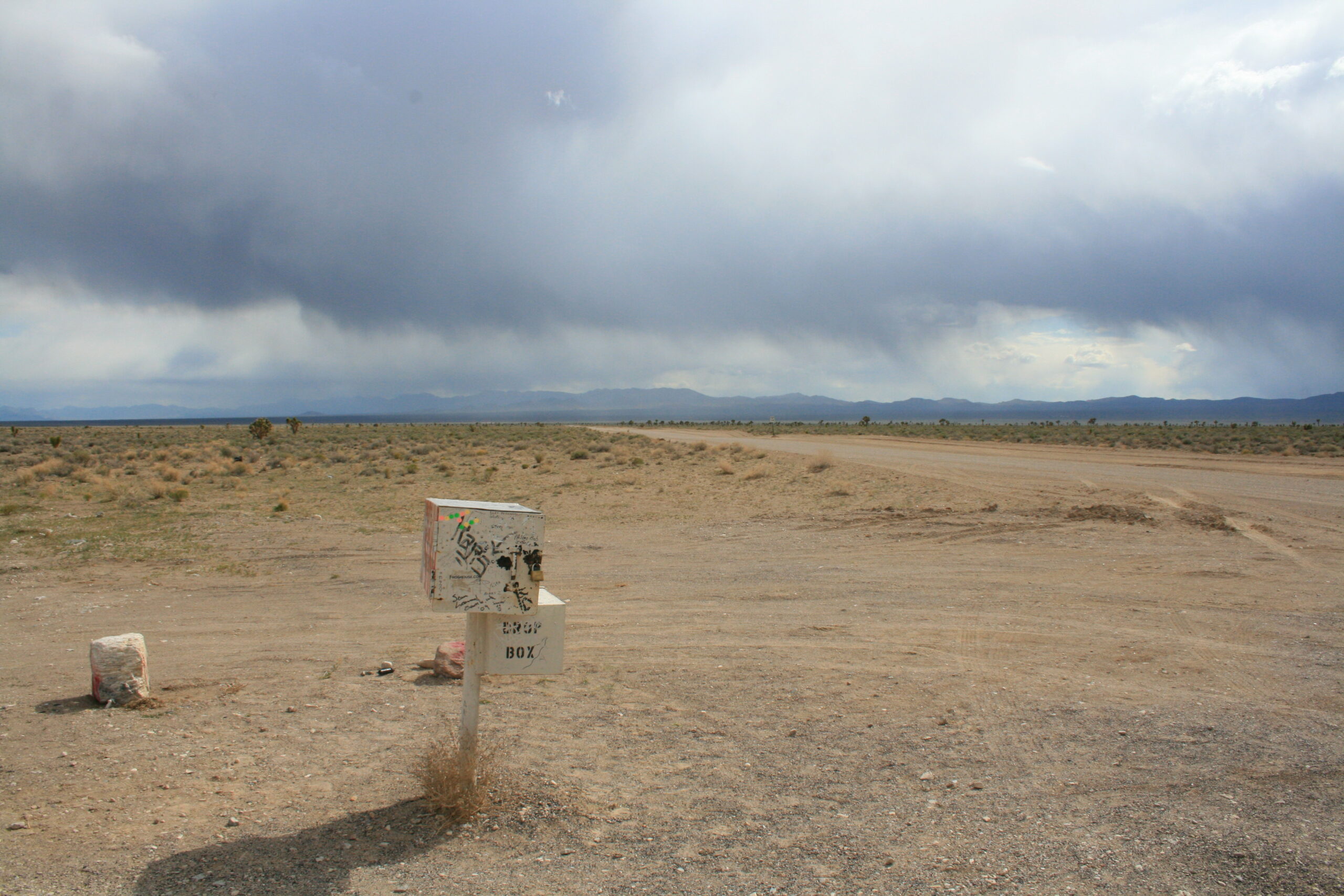 The famous Black Mailbox (now white) sits adjacent to a dirt road leading to the boundary of Area 51.