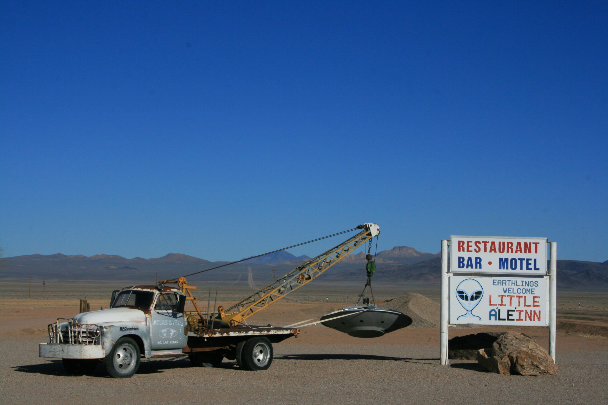 A vintage tow truck carries a flying saucer outside the Little A'le'inn motel in Rachel, Nevada.
