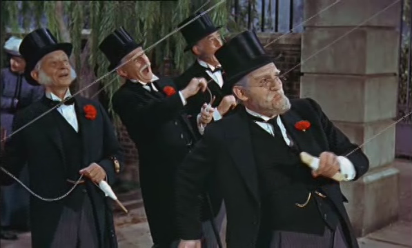 Formally-dressed bankers fly kites in Mary Poppins.