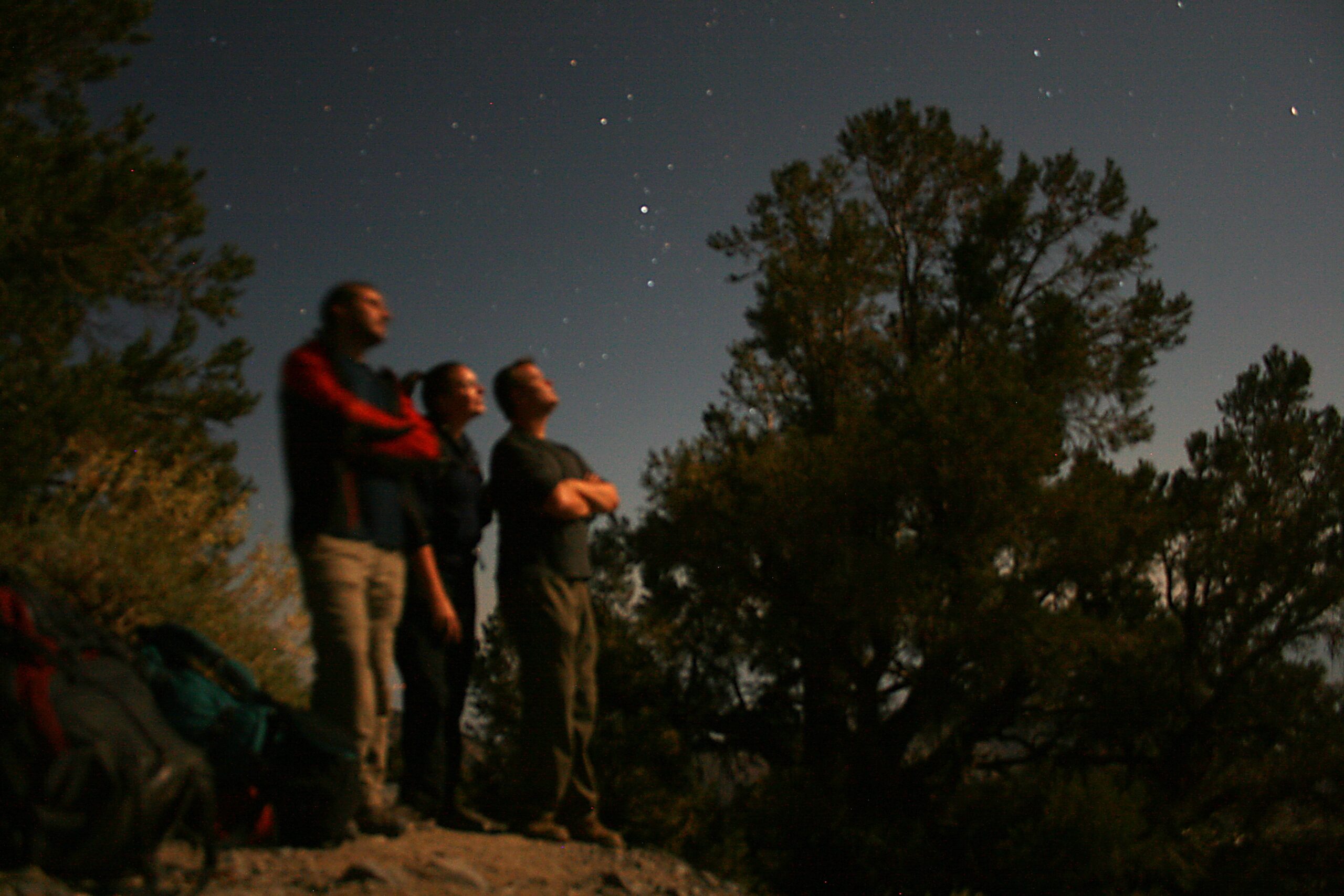 A 30-second exposure reveals hikers gazing at the moon near Death Valley&#039;s Telescope Peak.