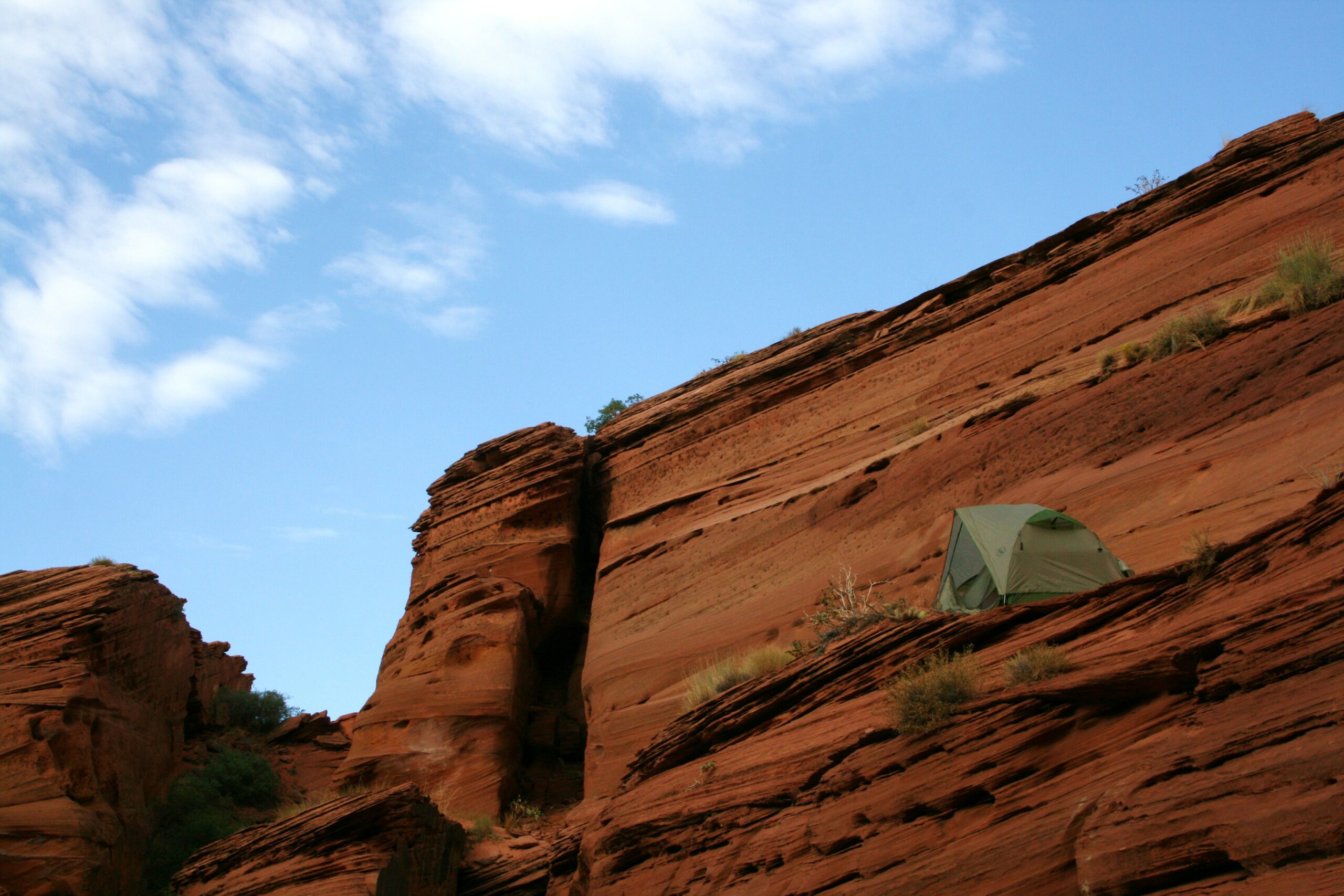 A tent sits high on a ledge near the Middle Route, in a place we named The Penthouse.