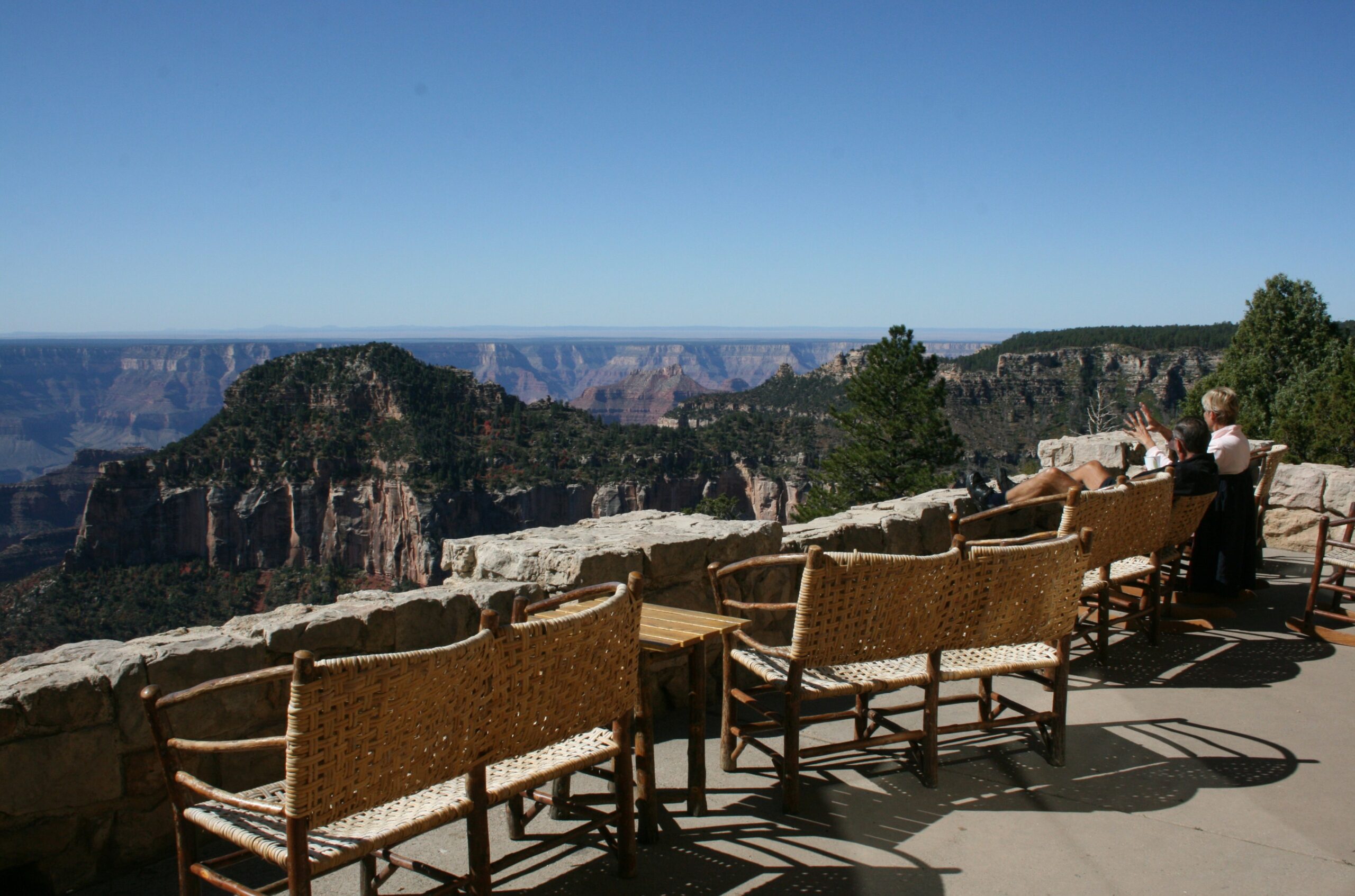 Tourists enjoy the view of the Grand Canyon on the patio at the North Rim Lodge.
