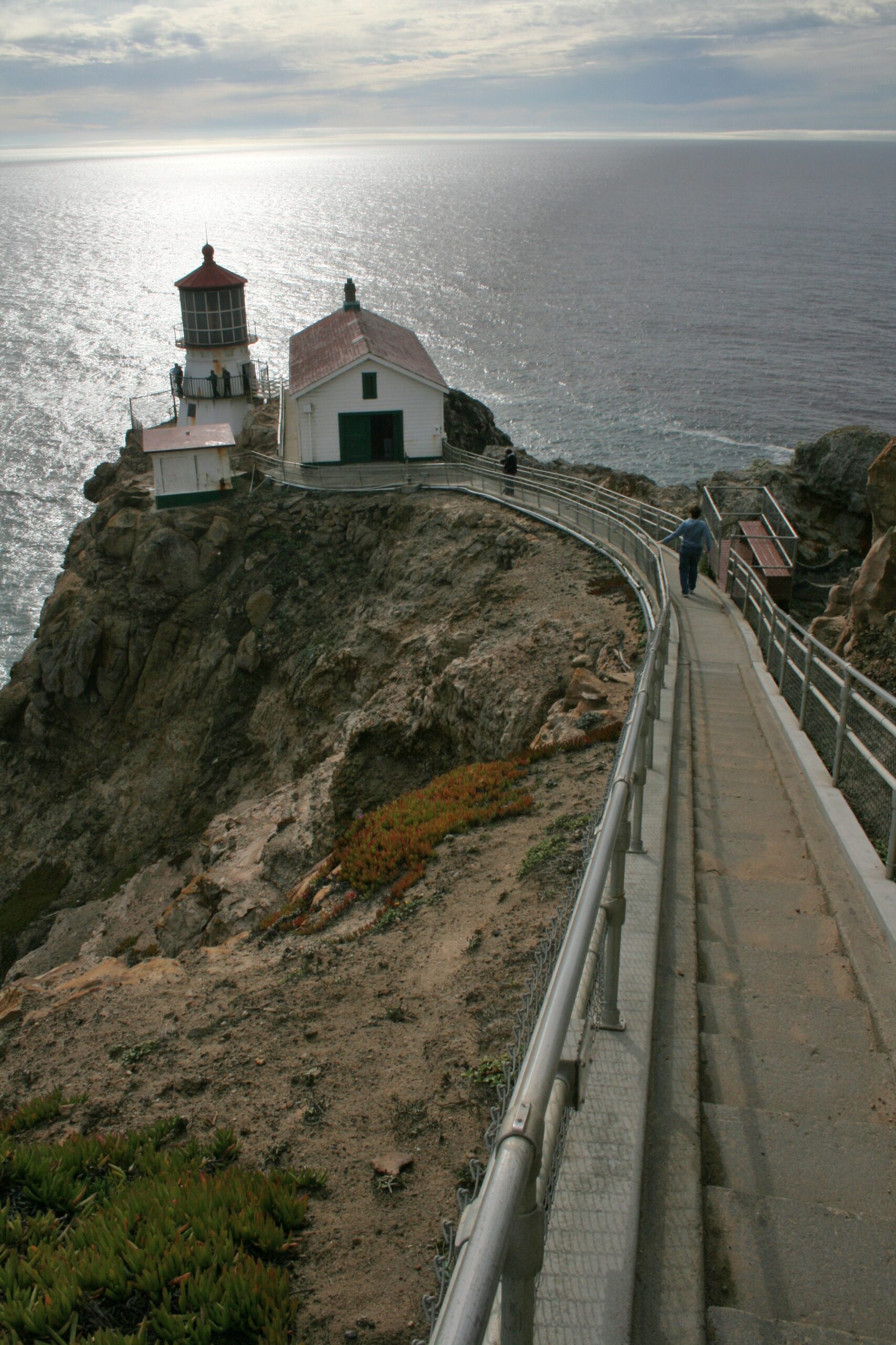 The Point Reyes Lighthouse sits at the bottom of a long staircase on the edge of the Pacific Ocean.