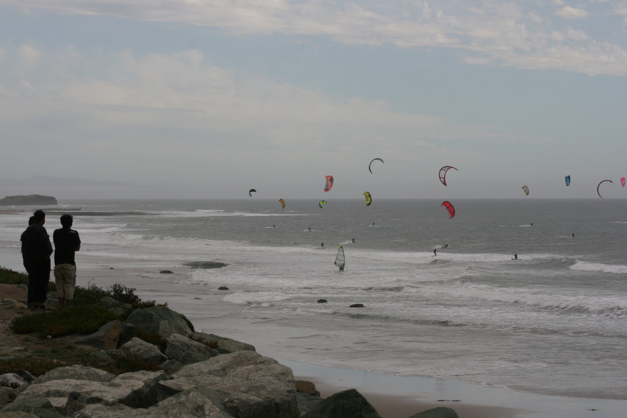 Children watch kite surfers on the Pacific Ocean near Santa Cruz, California.