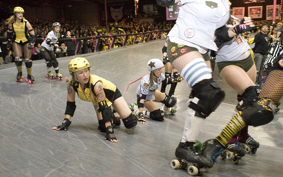The championship bout between The Tough Cookies and The Swarm heats up as athletes fall to the track floor. (photo by Michael Zampelli)