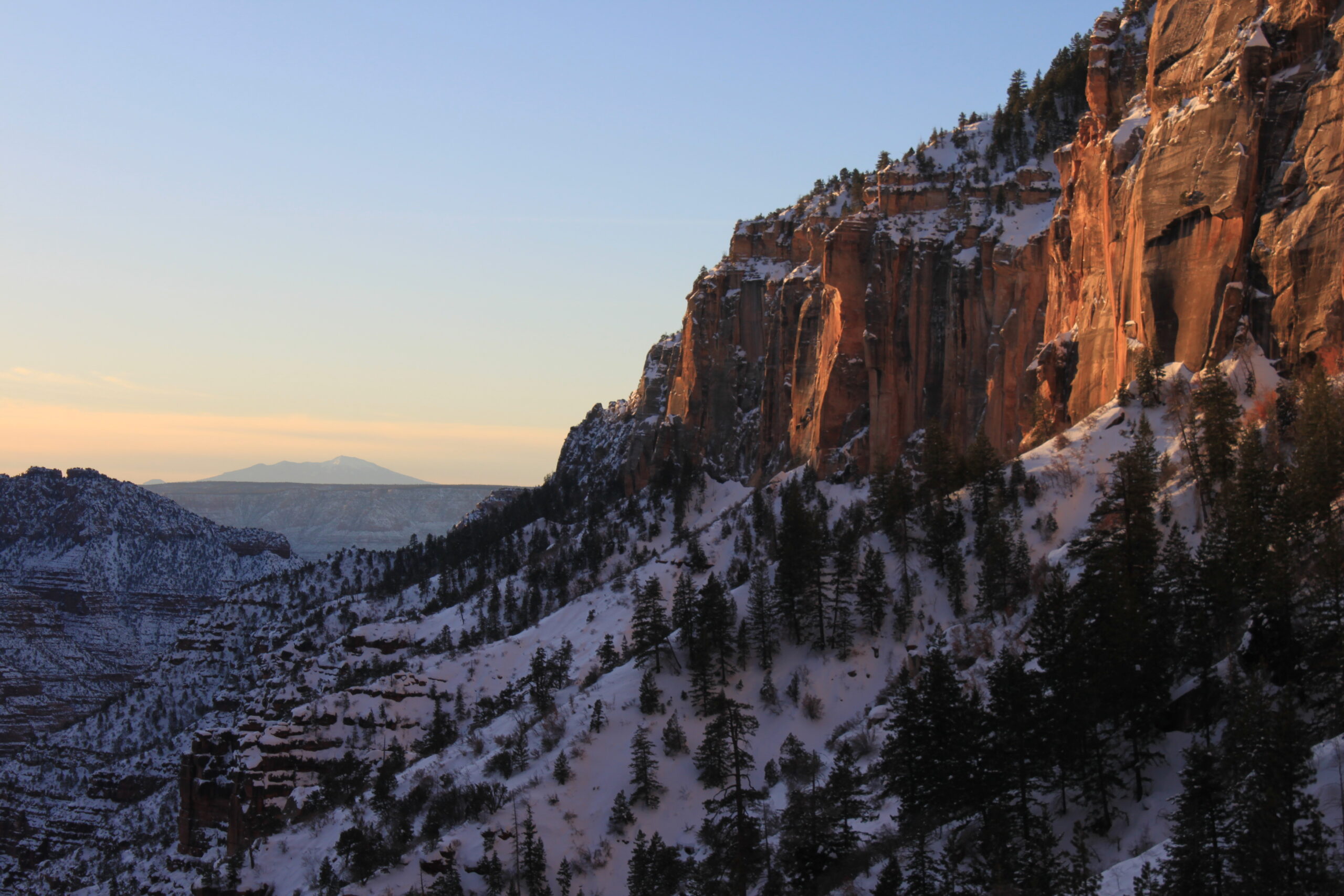 A sunset reflects on rocks over the Grand Canyon's North Kaibab Trail.