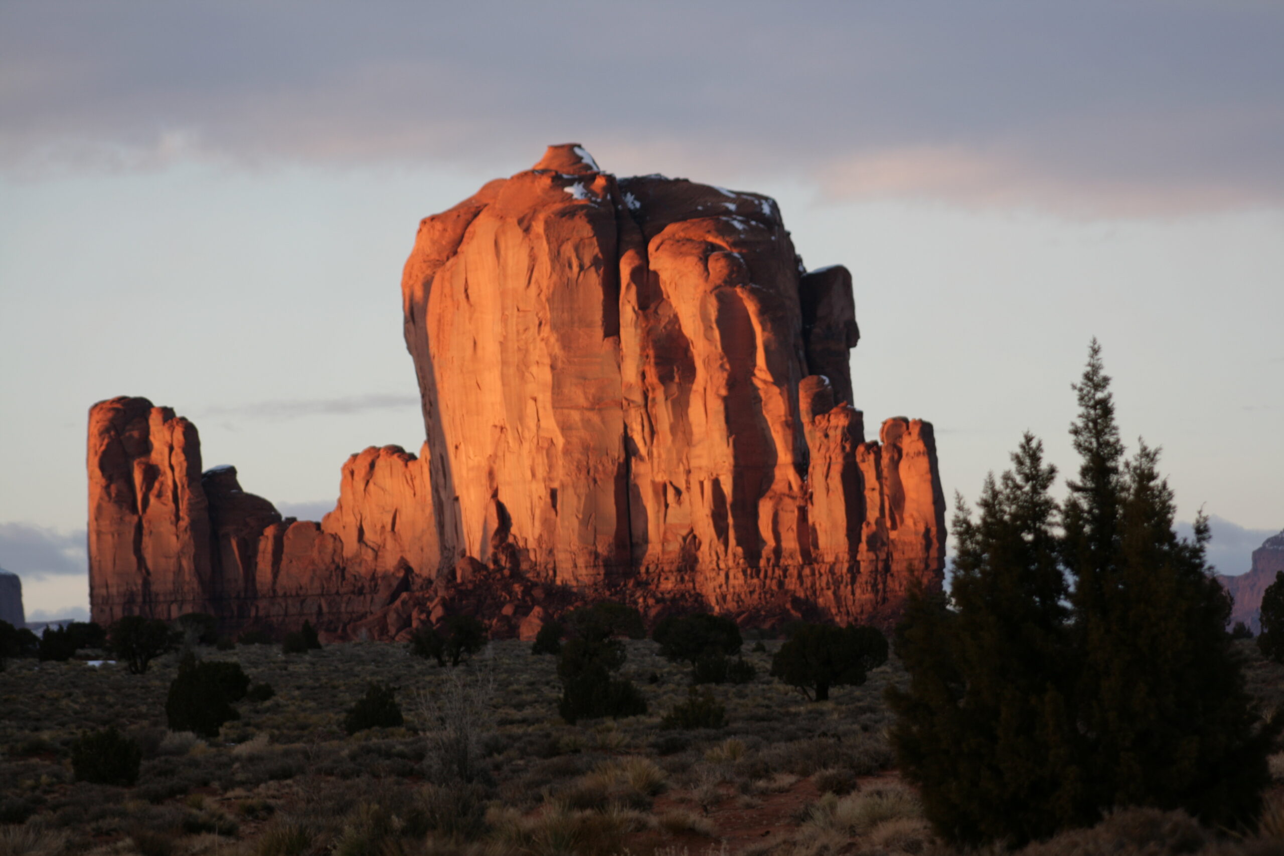 Sun reflects off a butte in Monument Valley.