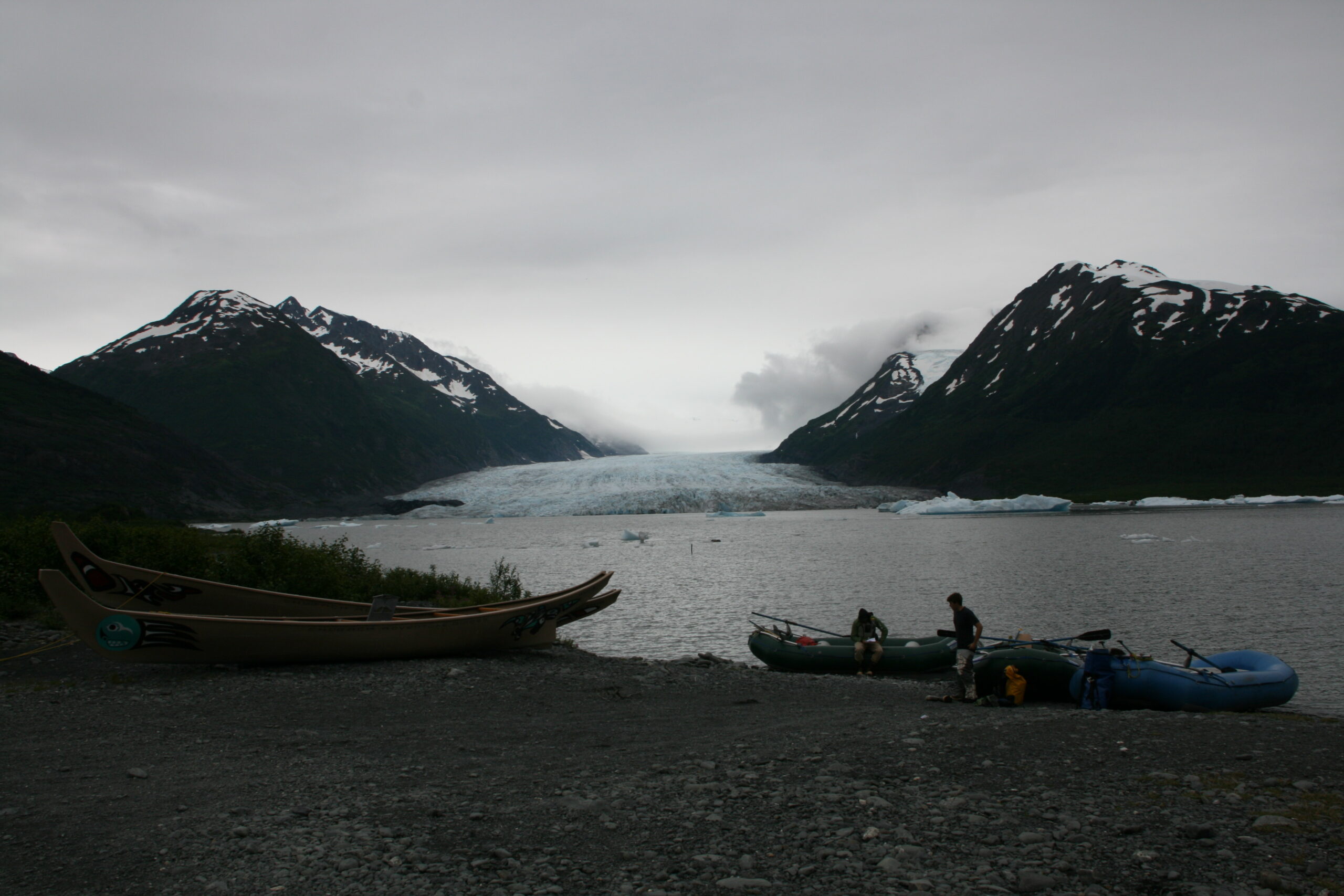 Rafts and canoes sit in front of Spencer Glacier in Alaska's Chugach National Forest.