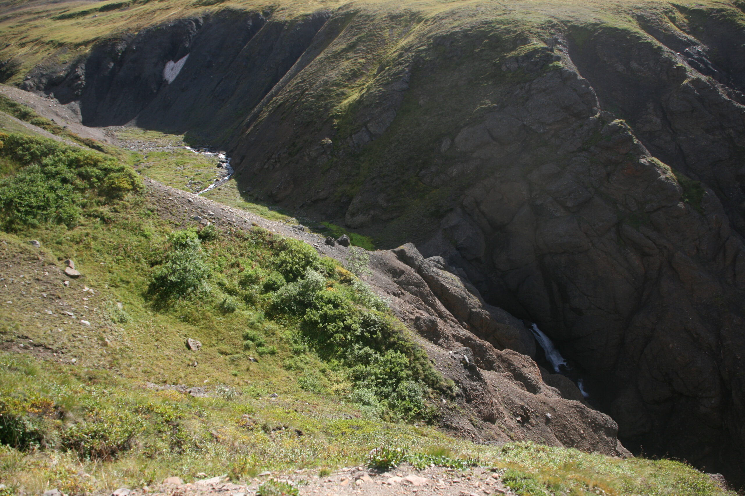 An impassable waterfall blocks hikers following Windy Creek's banks.