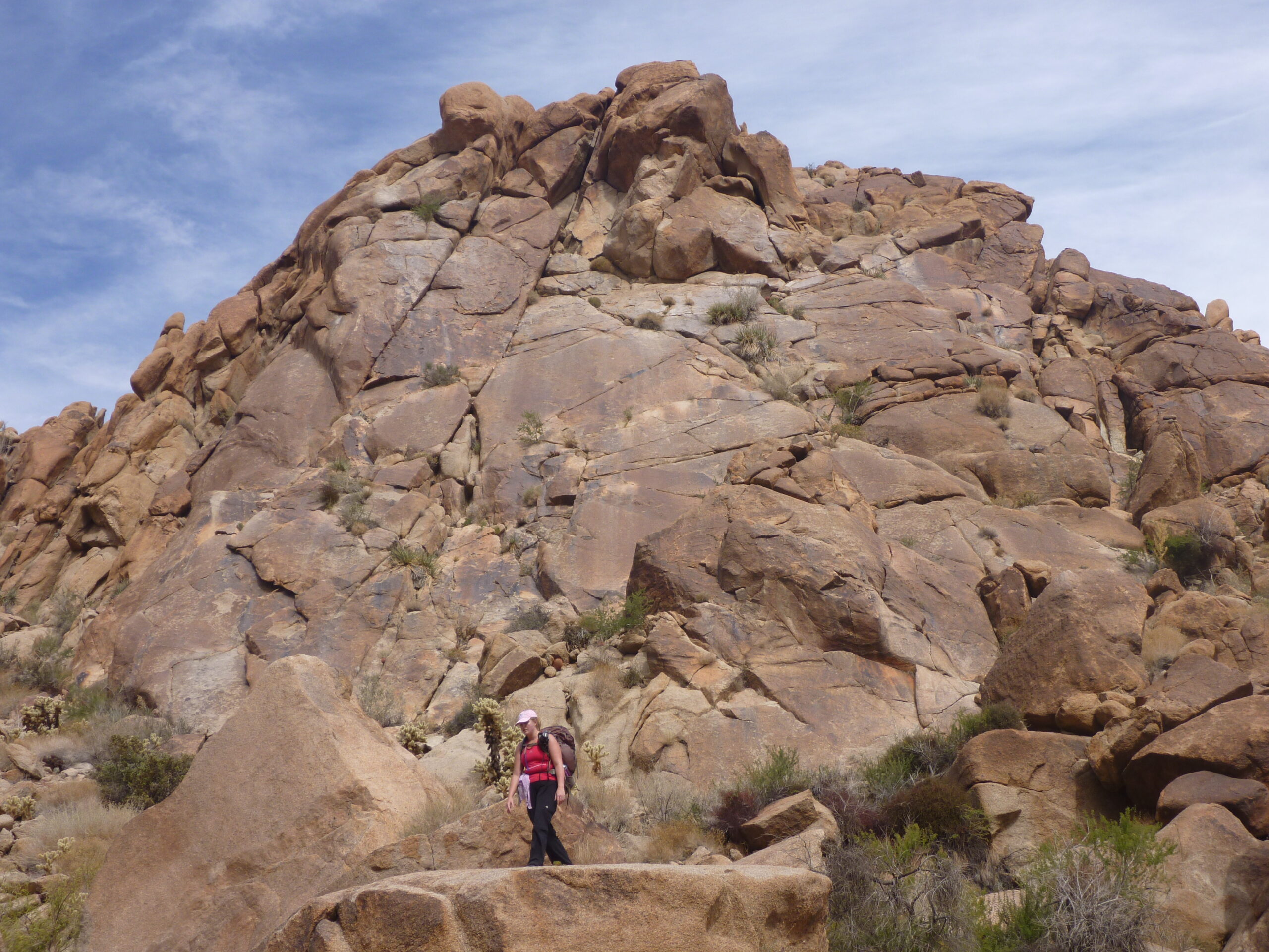 Wendy climbs down rocks toward Victory Palms.