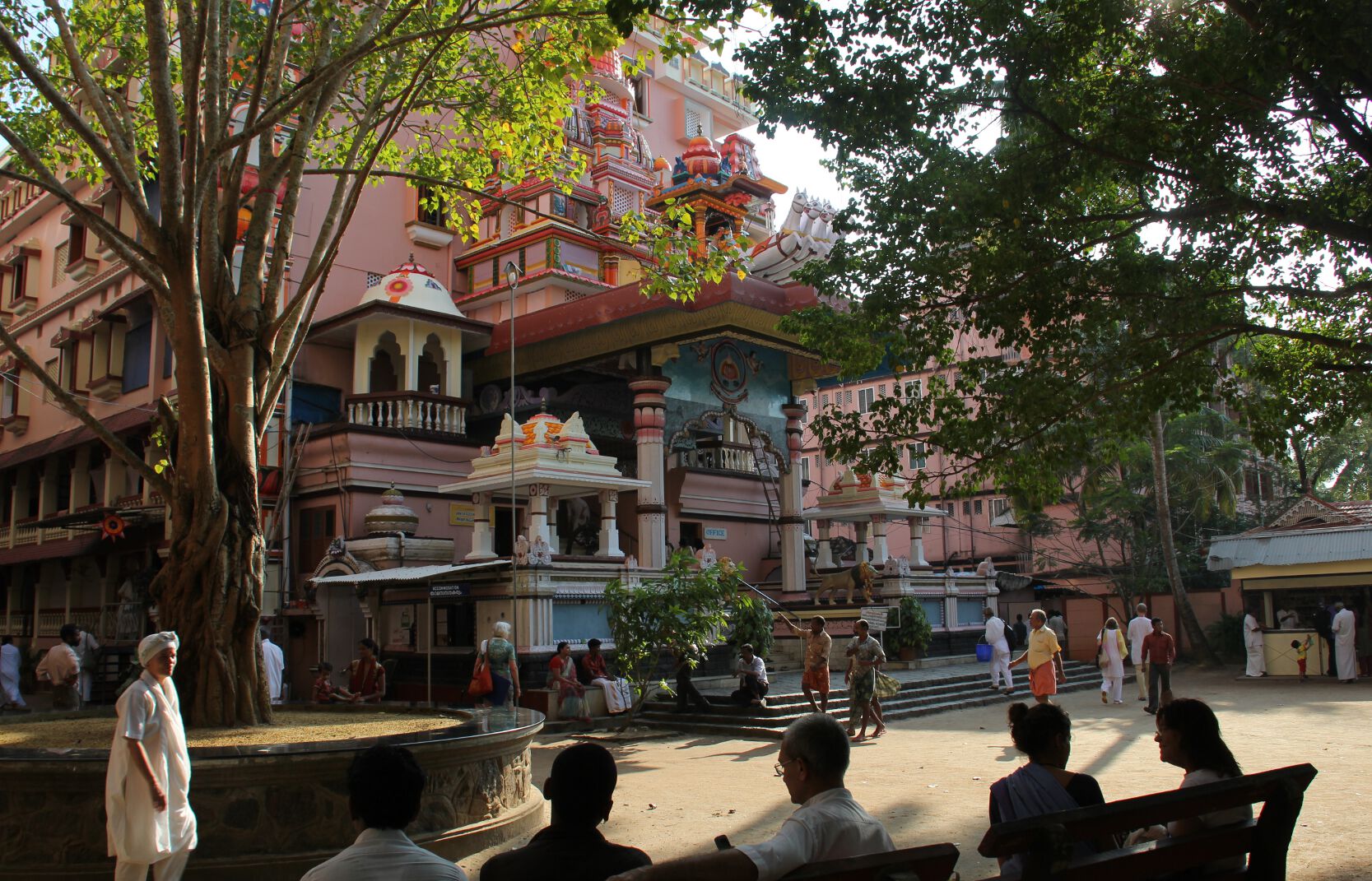 Devotees sit outside the ashram's temple in Amritapuri, India.