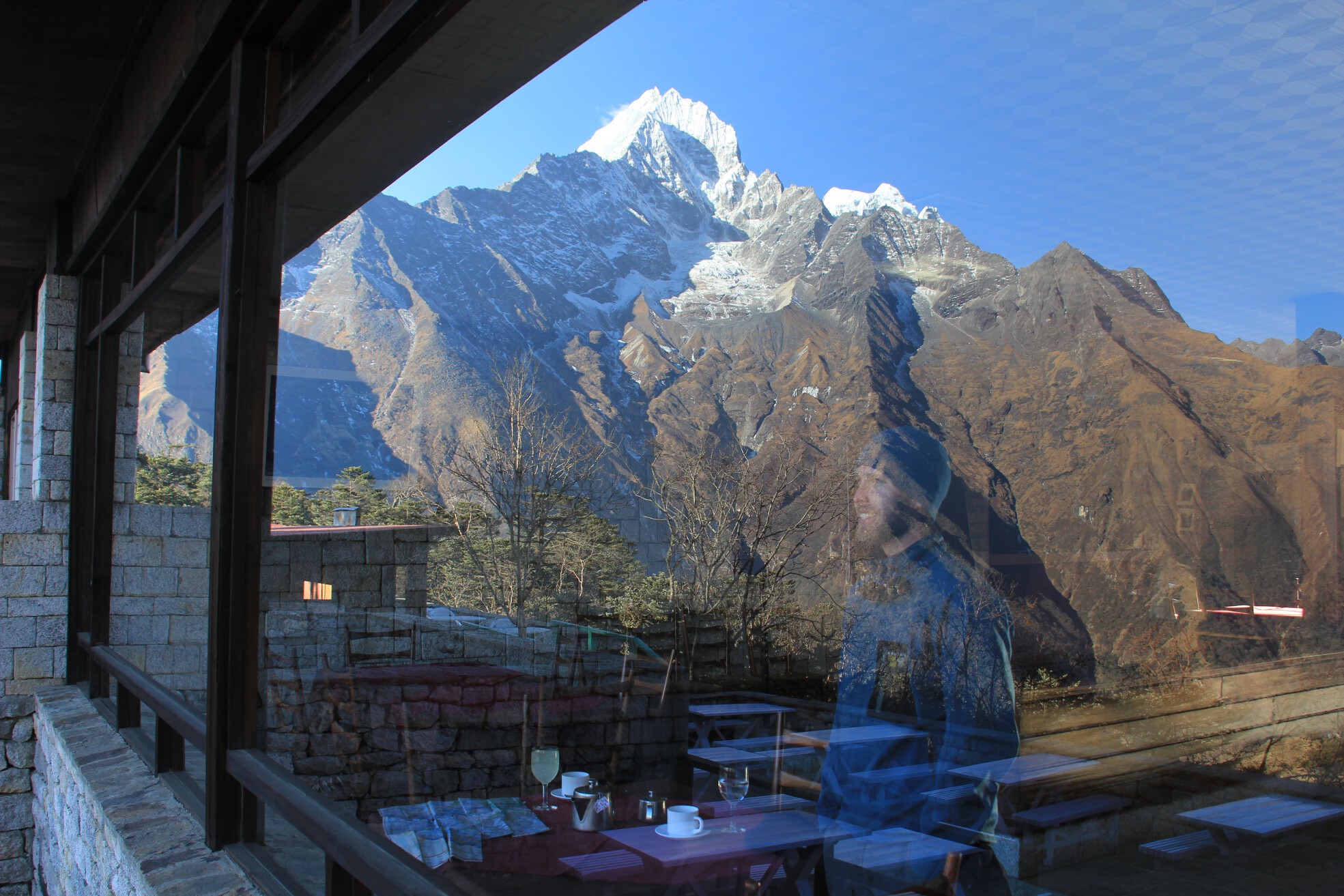 Brian gazes at Mount Everest through the window of the Hotel Everest View above Namche Bazaar, Nepal.