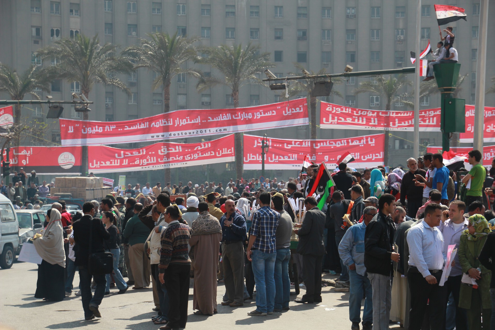 Protesters hold banners in Cairo's Tahrir Square on the day before a countrywide vote on constitutional amendments.