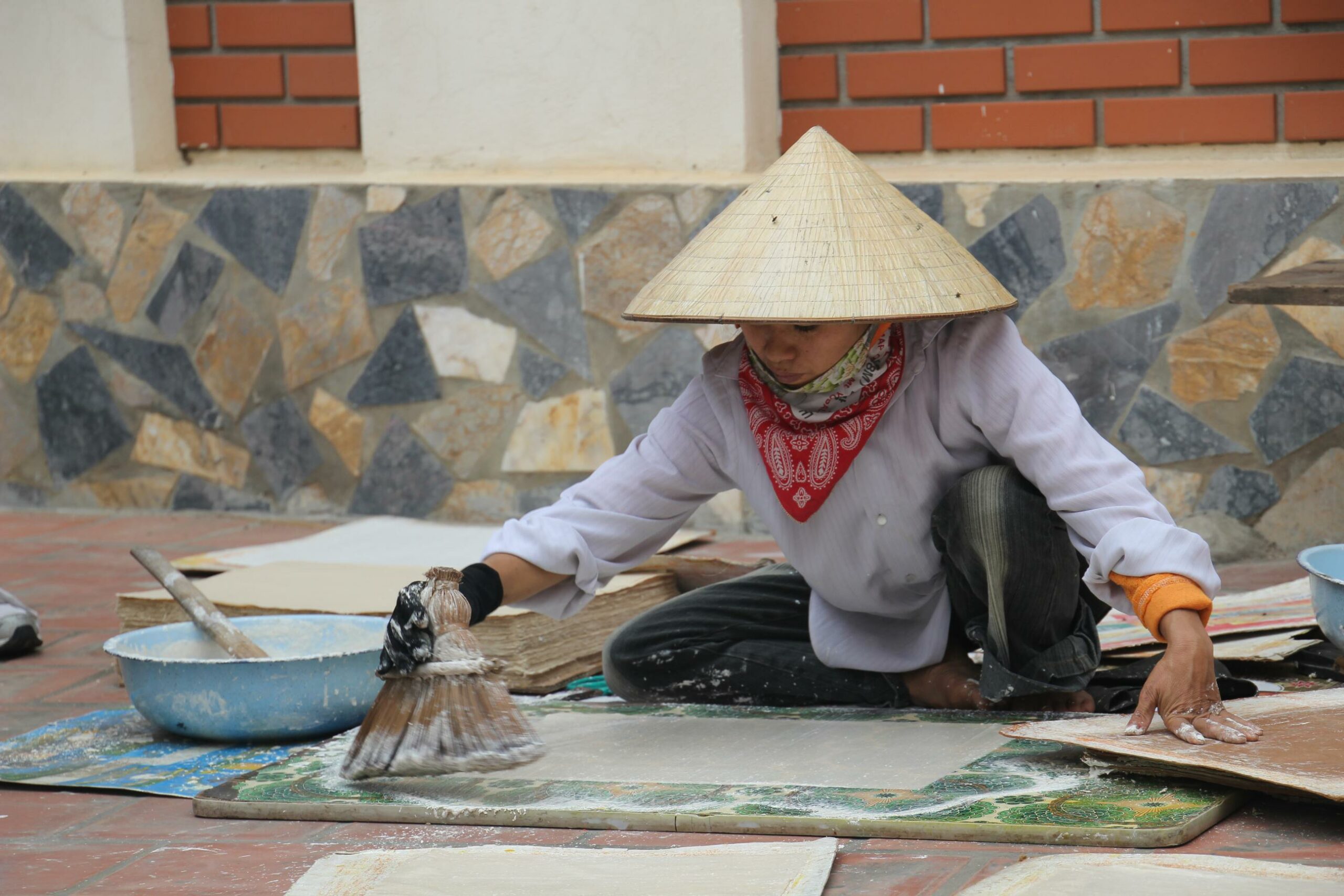 A woman makes paper by hand in Dong Ho, Vietnam.