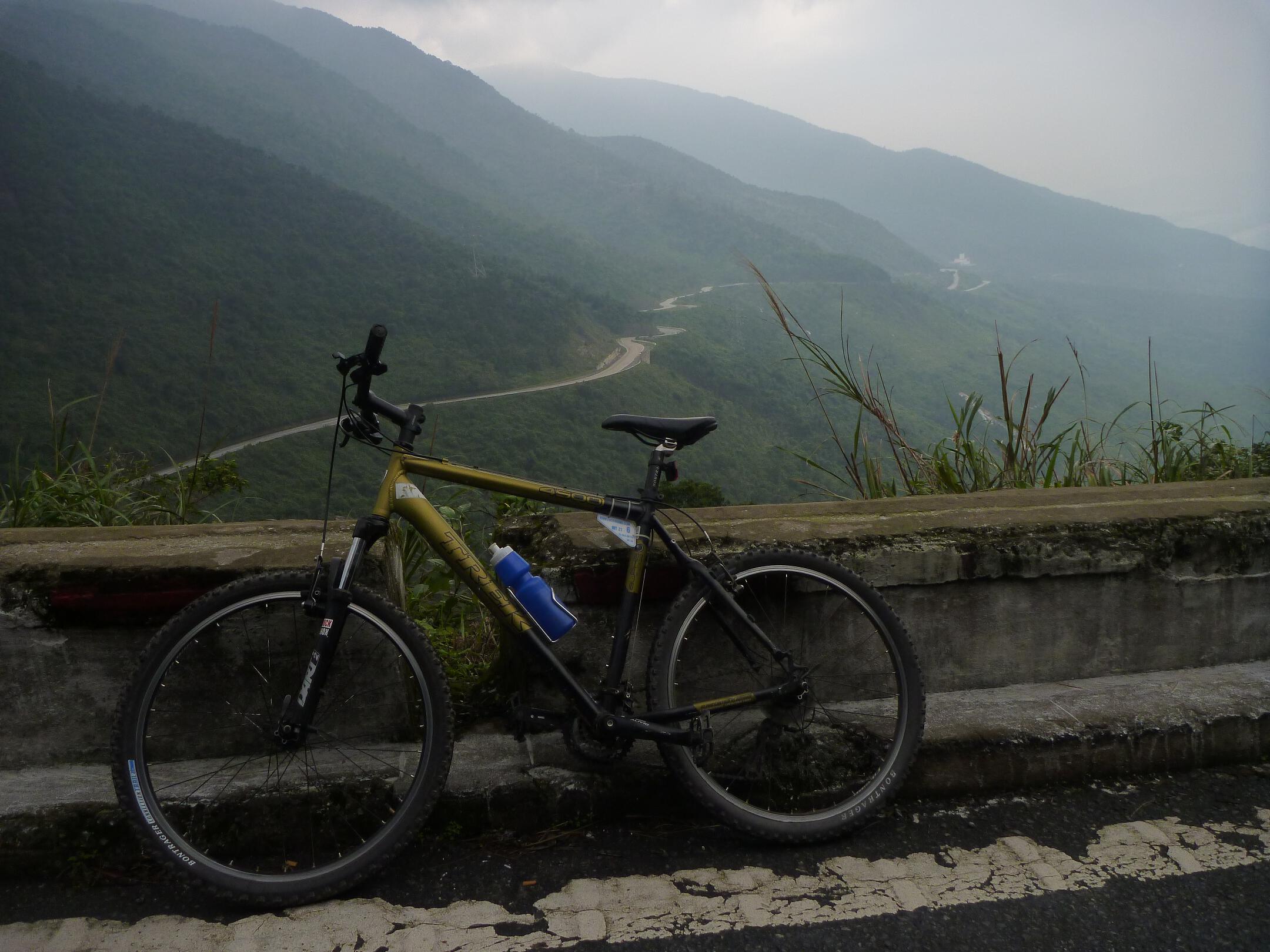 A bicycle sits on the road on Vietnam's Hai Van Pass.