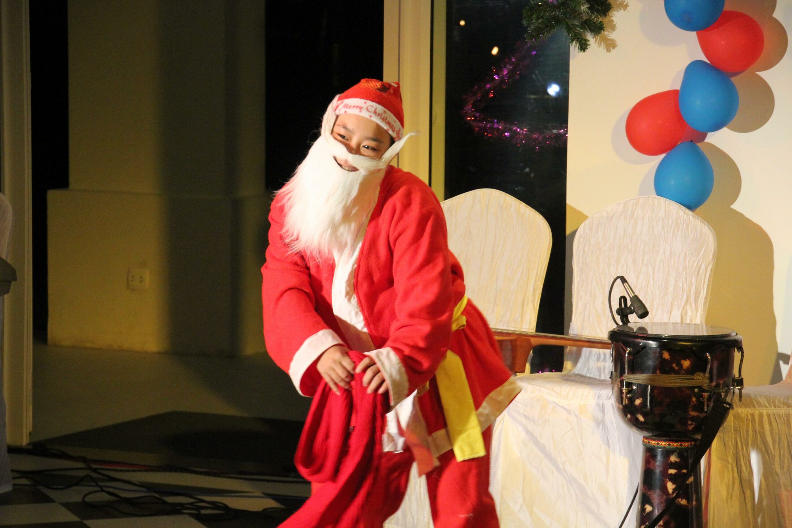 A Vietnamese boy dons a Santa Claus suit in a Christmas pageant in Hoi An, Vietnam.