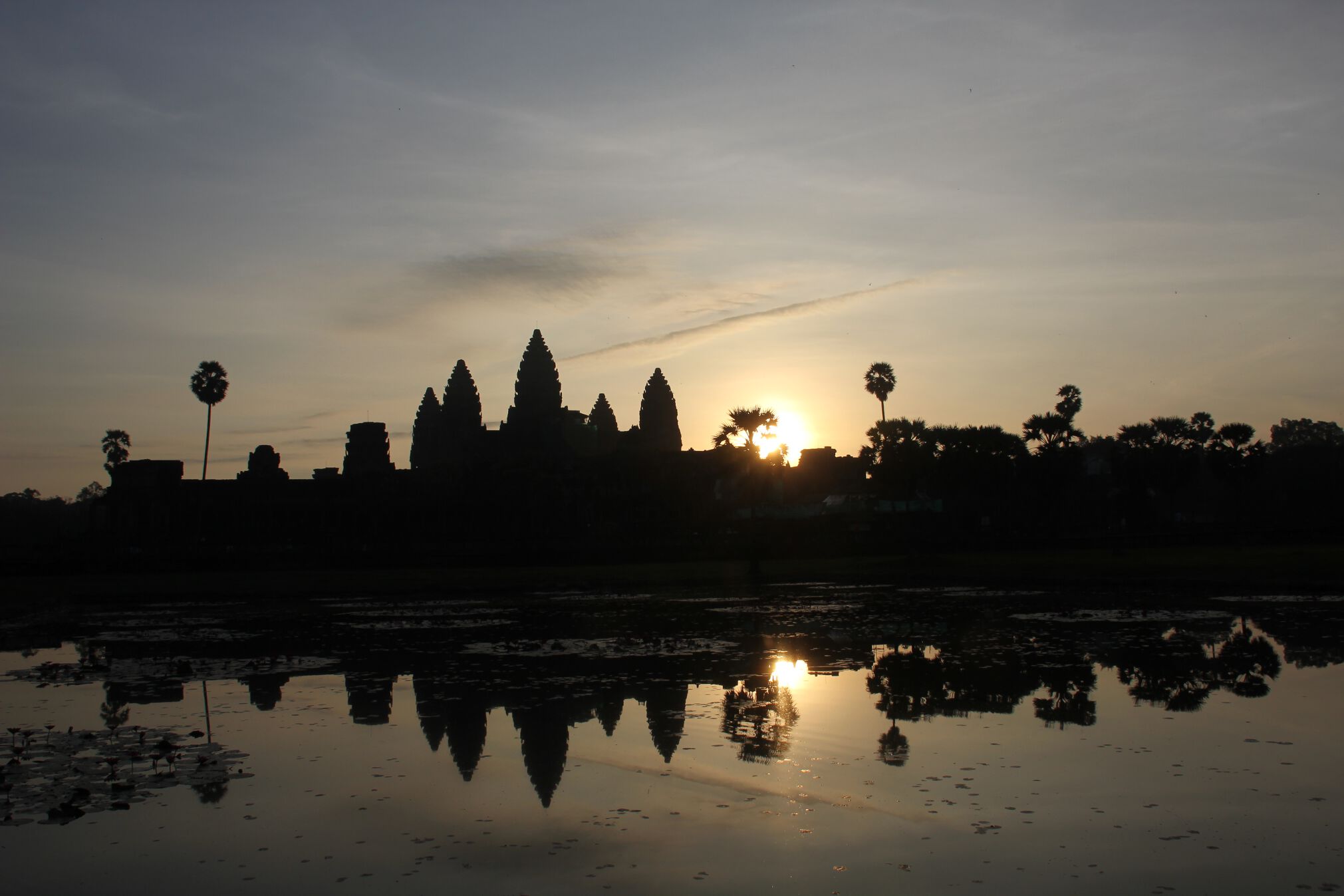 The sun rises behind Angkor Wat early in the morning in Angkor, Cambodia.