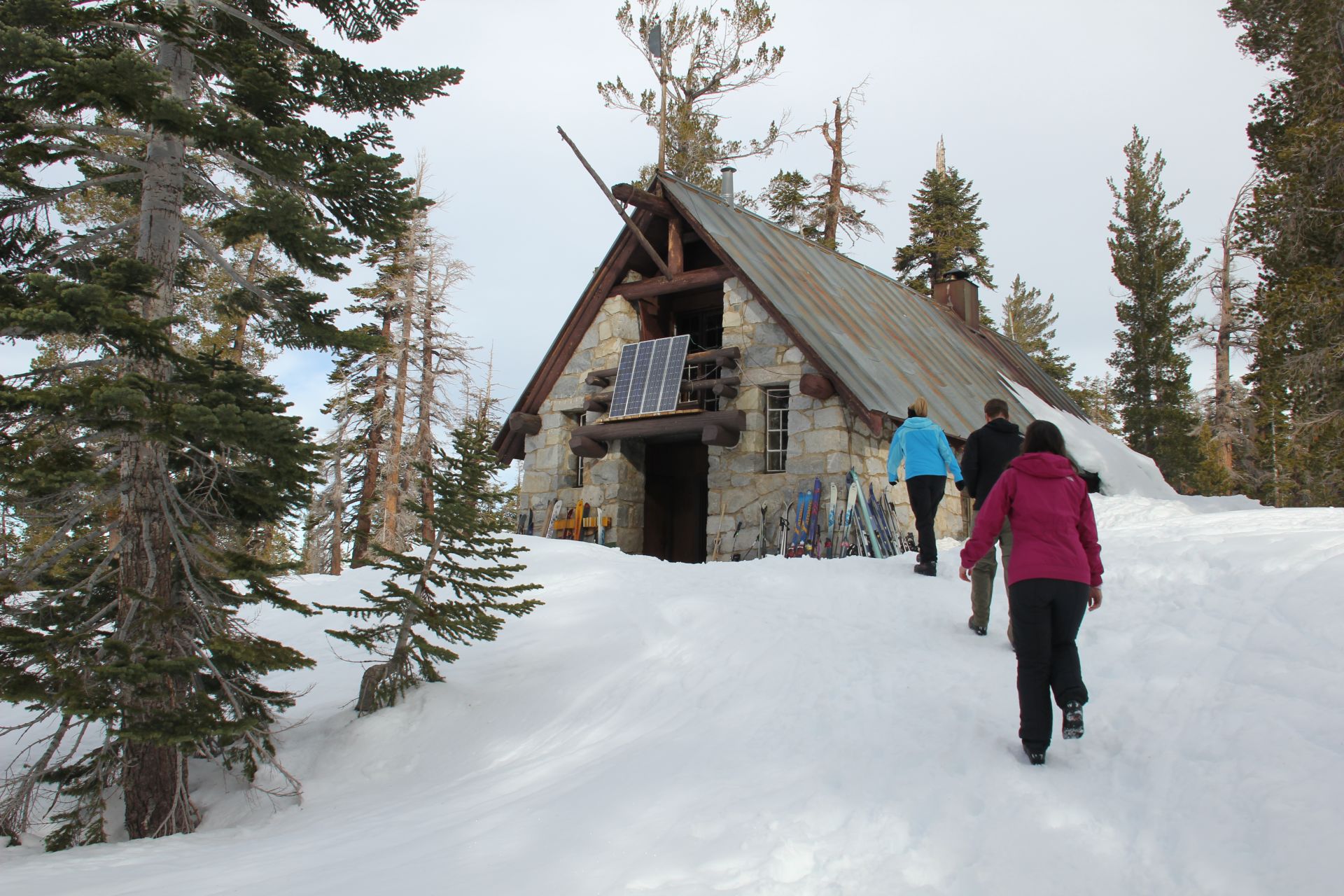 Hikers walk toward Yosemite's Ostrander Ski Hut.