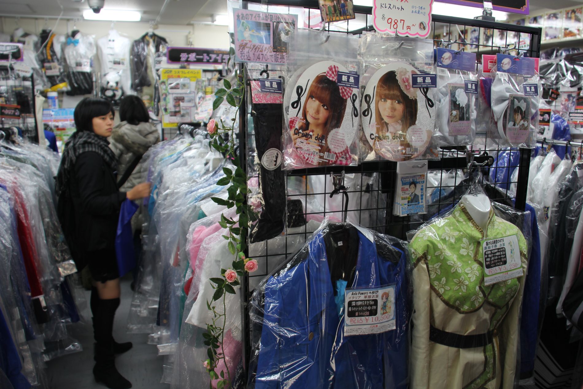 A cosplay girl browses for costumes on Otome Road in Tokyo, Japan.