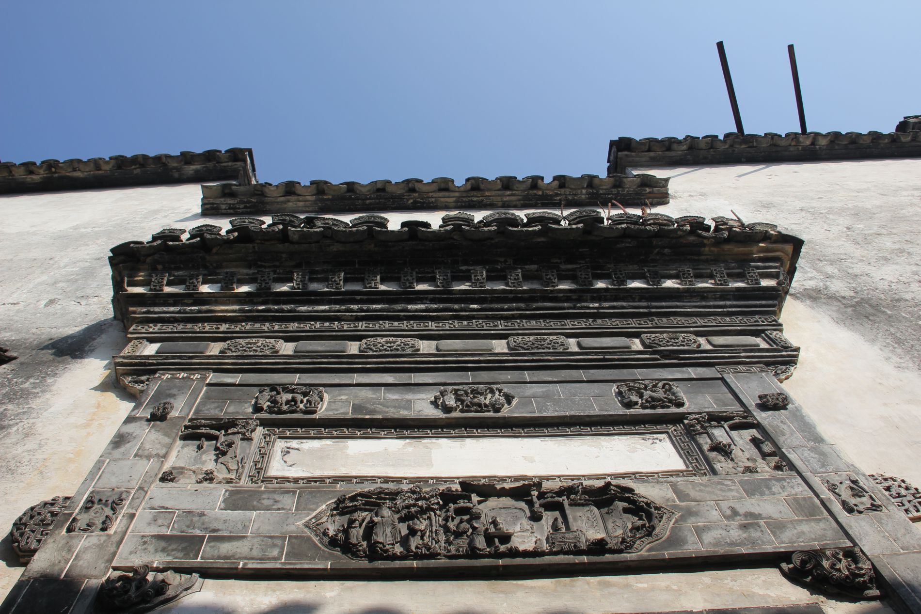 Stone carvings greet visitors at the entrance of Xidi's Yingfu Hall.