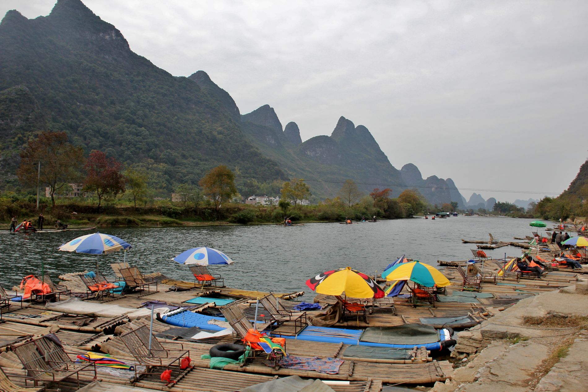 Bamboo rafts wait for tourists on the Yulong River in Yángshuò, GuÄƒngxÄ«, China.