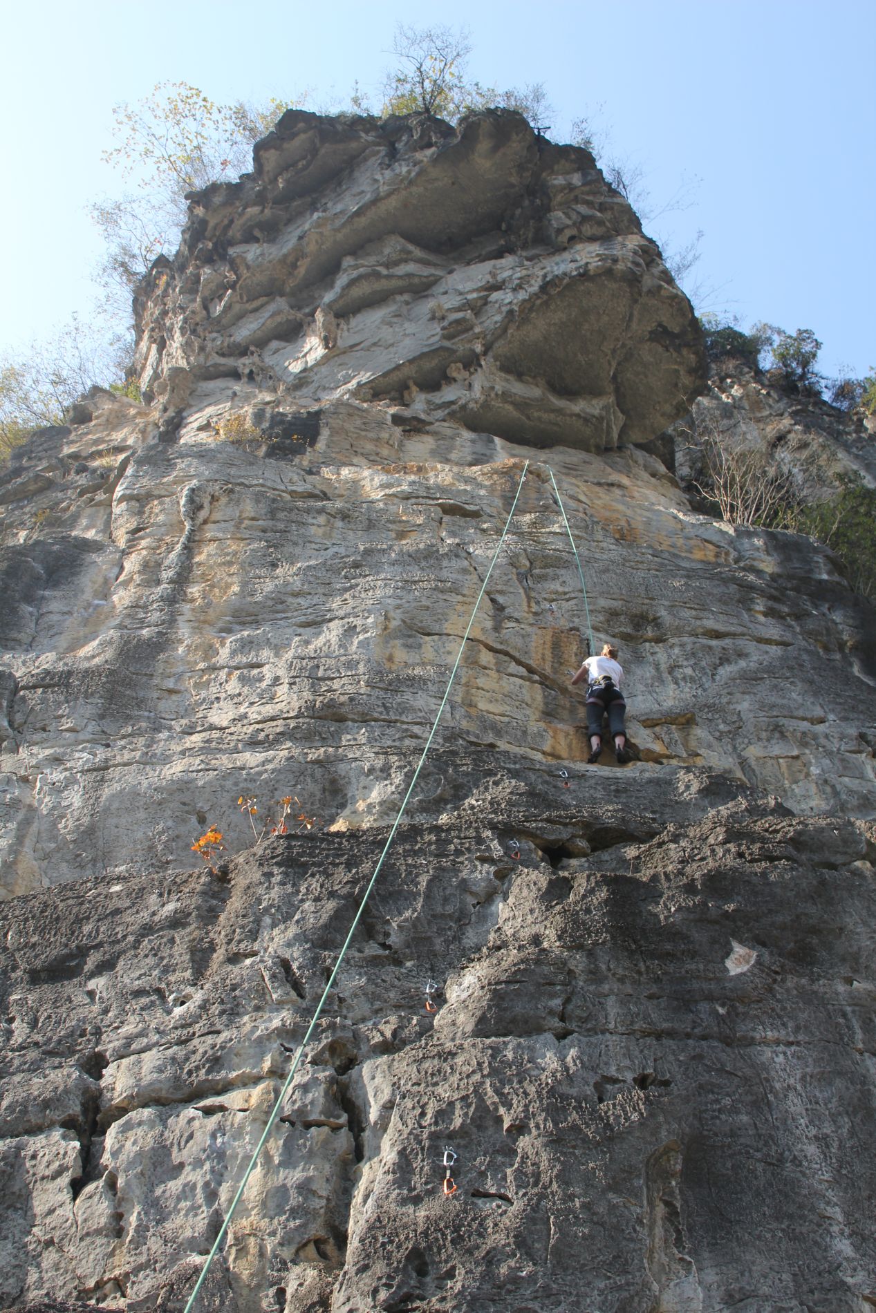 A woman climbs The Egg in Yángshuò, GuÄƒngxÄ«, China.