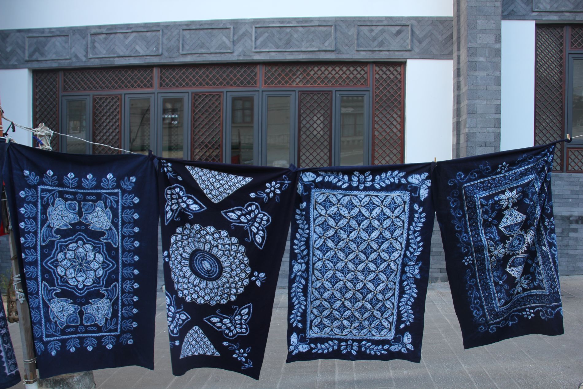 Bai wax-dyed cloth hangs from a clothesline in a market in DÃ lÇ??, China.