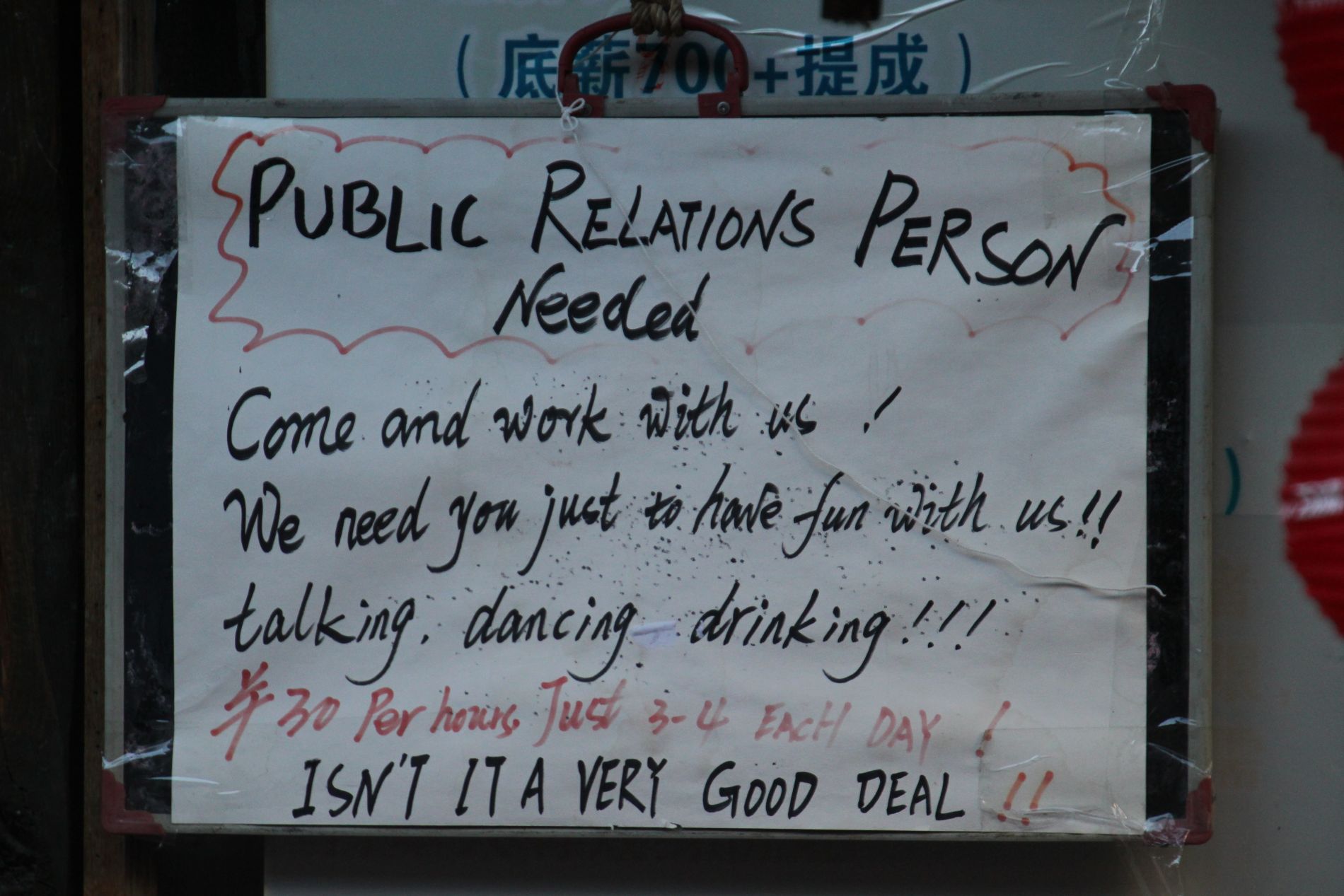 A help-wanted sign hands in DàlÇ??, China.