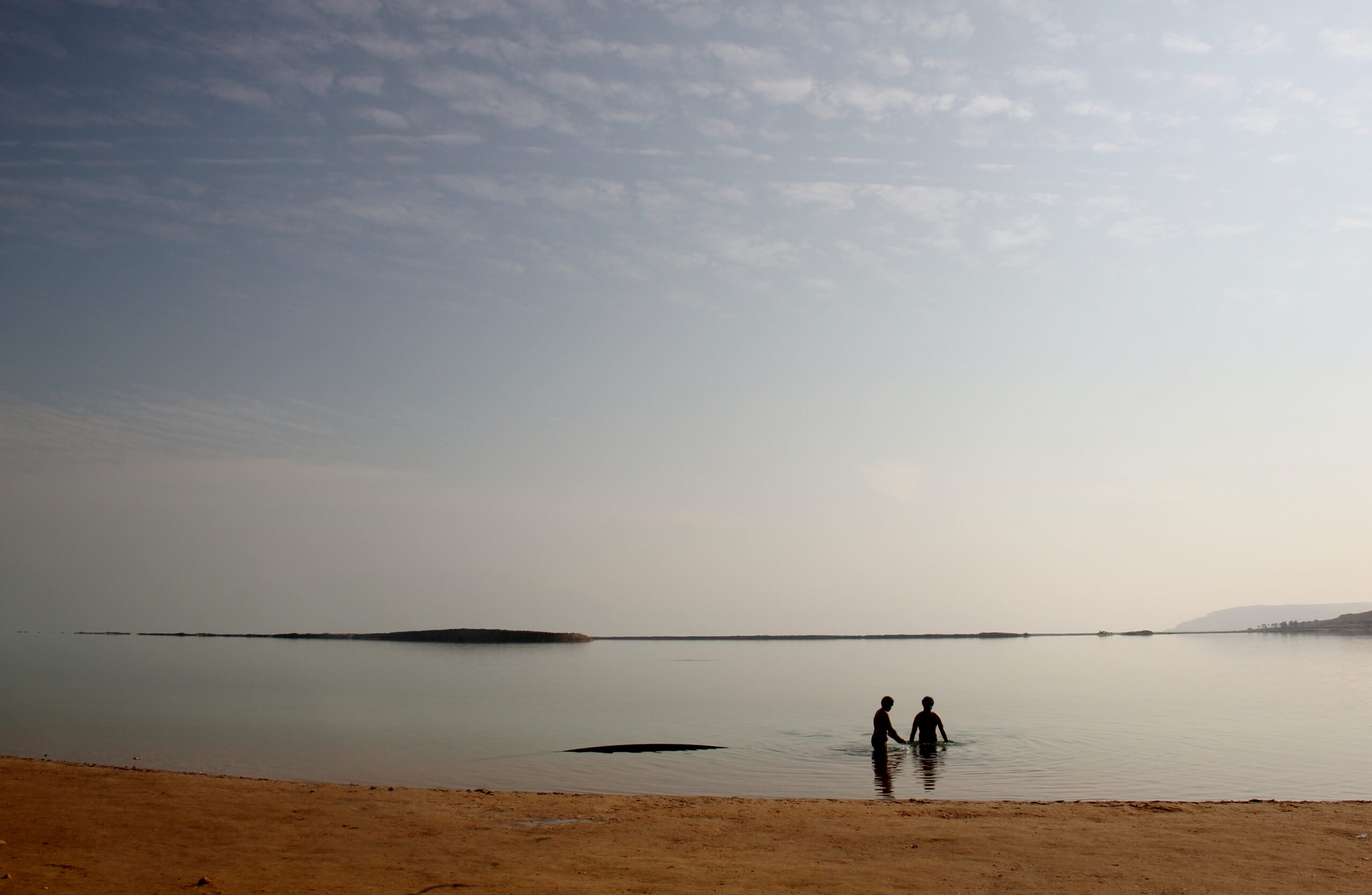 People swim at Ein Bokek&#039;s public beach on the Dead Sea in the West Bank near Jerusalem, Israel.