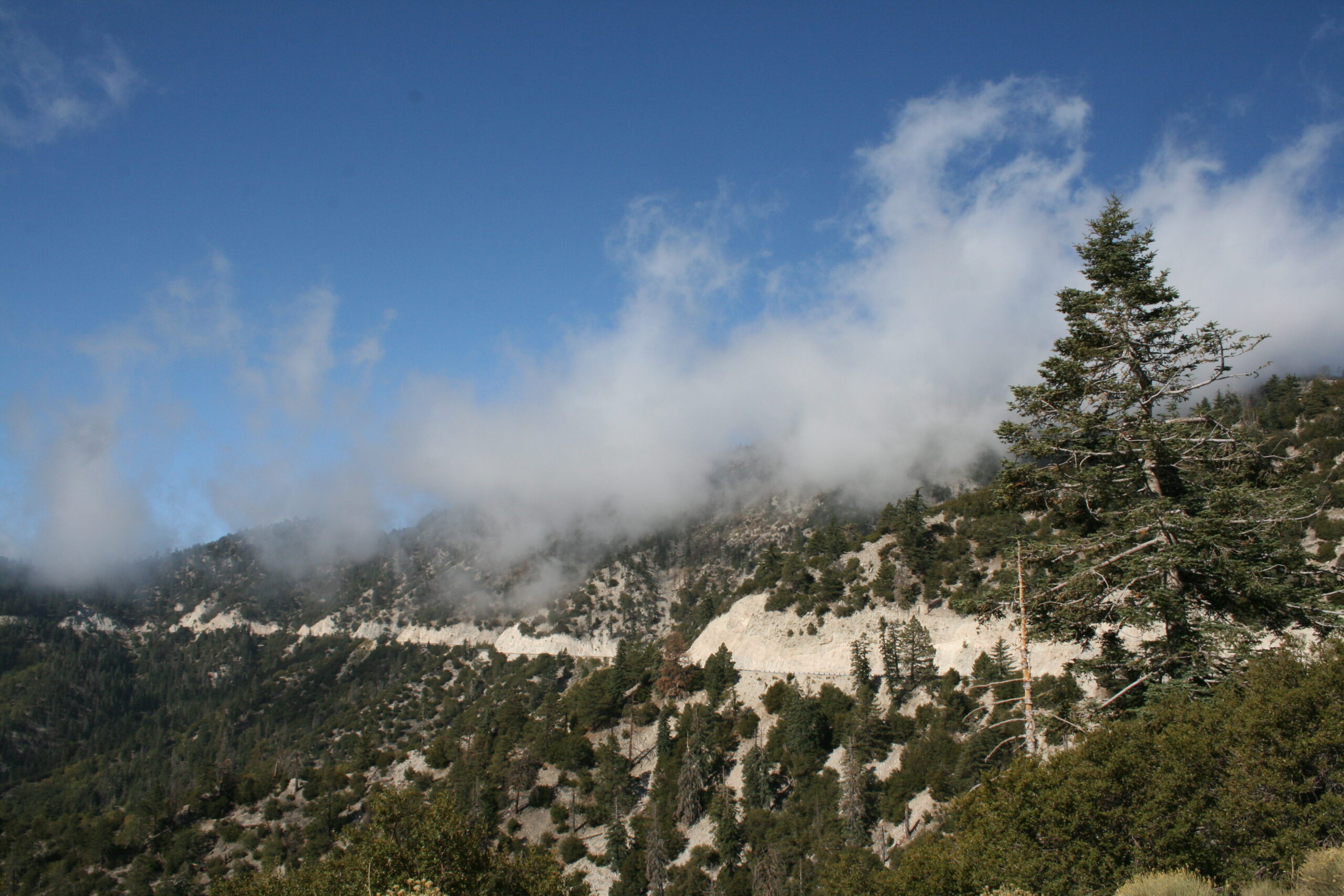 Clouds hover over the winding road to Big Bear Lake, California.