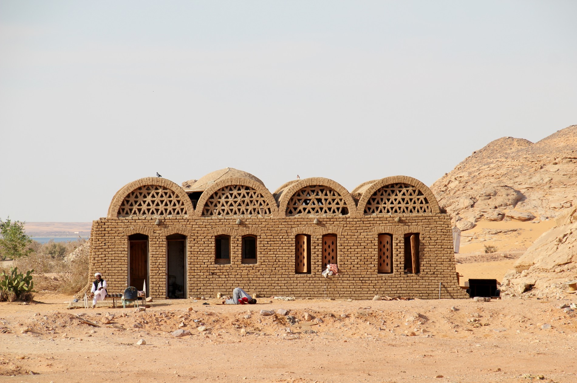 An Islamic man prays in front of a building in Nubia, Egypt.