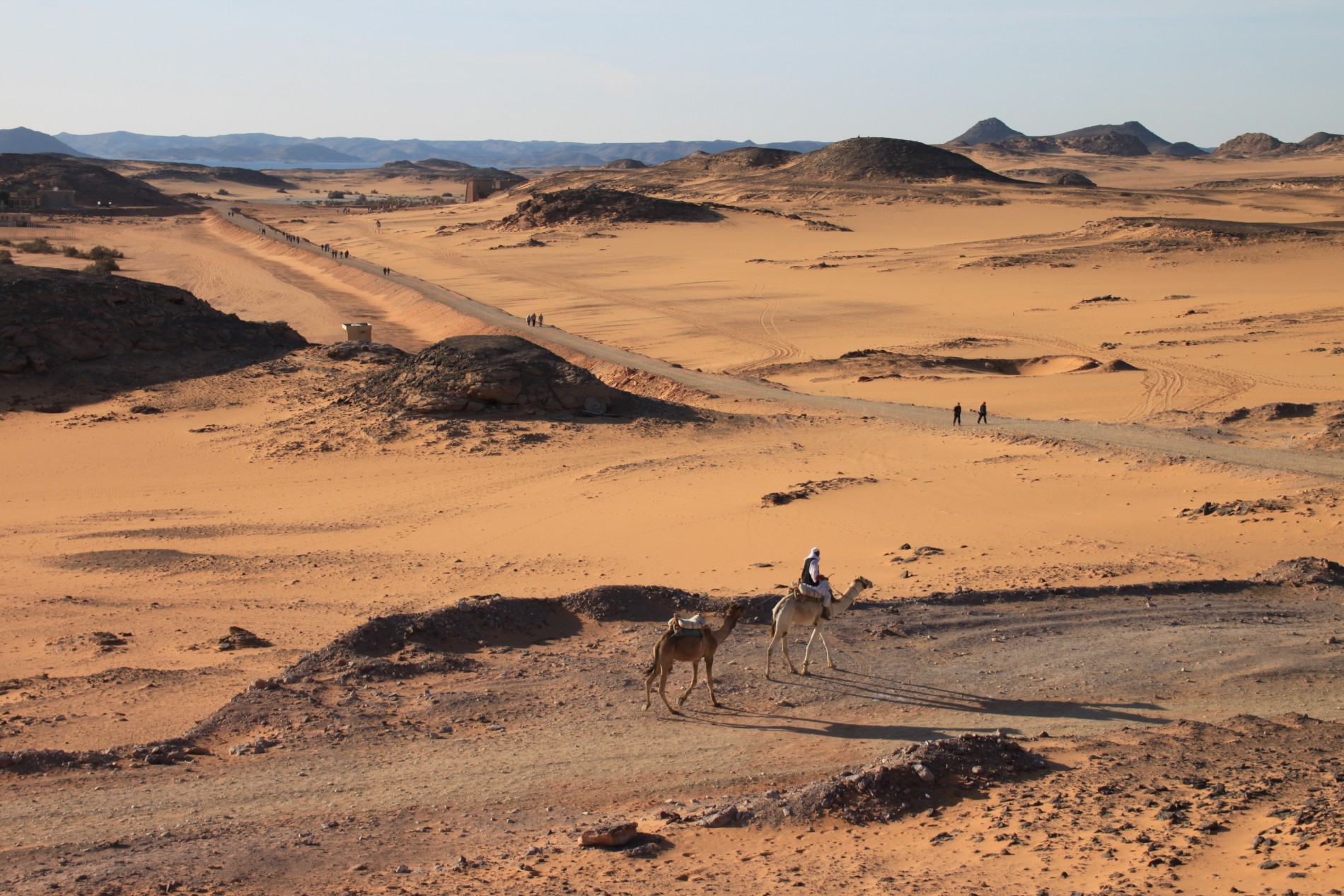 Tourists ride camels across the Nubian Desert near Wadi es-Sebua in Nubia, Egypt.