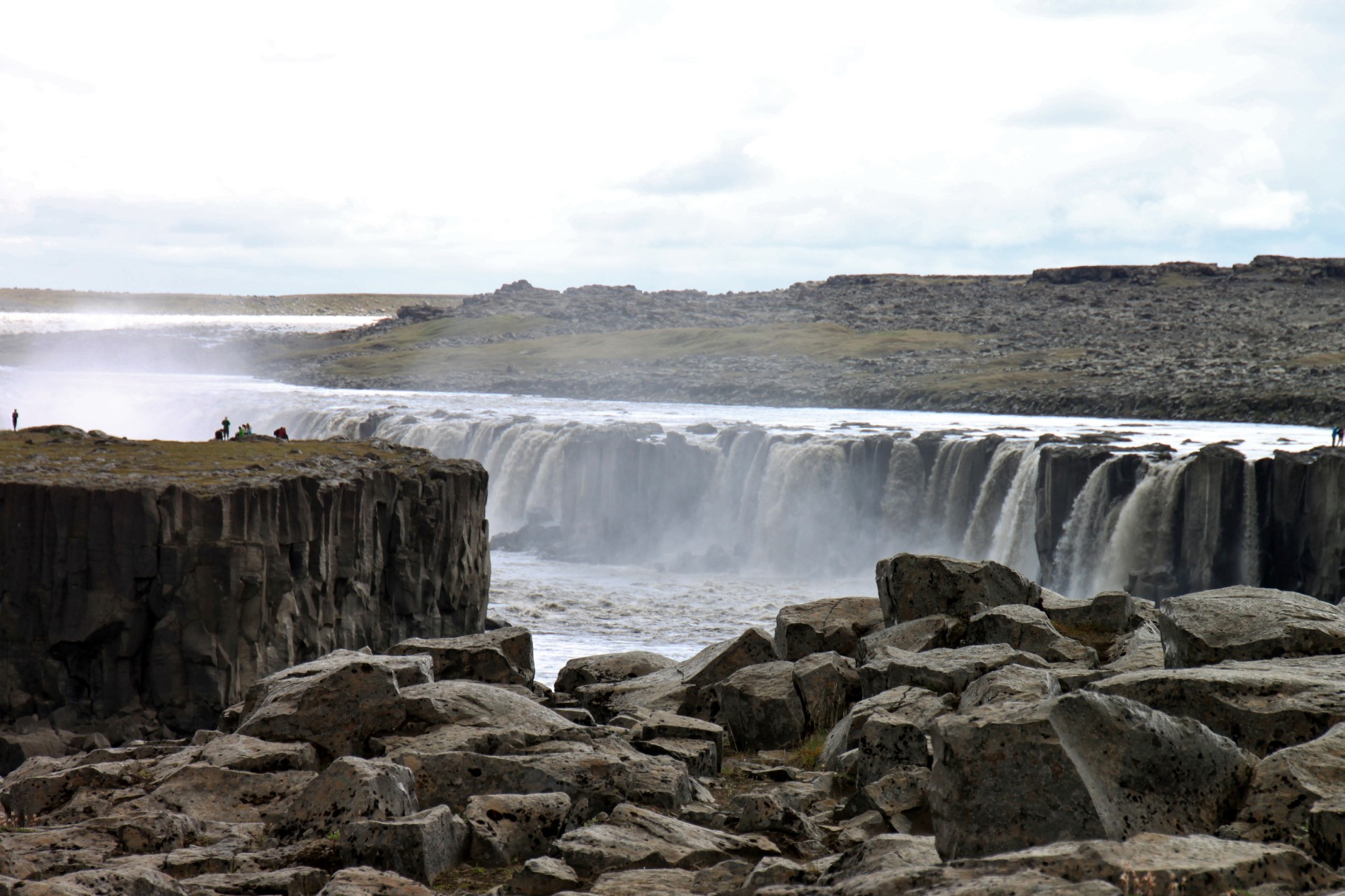 Tourists admire Selfoss Waterfall in Northern Iceland.