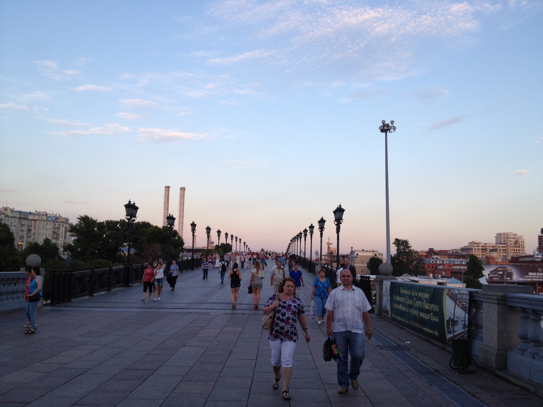 Pedestrians walk over Patriarshy Bridge toward the Red October nightlife hotspot in Moscow.