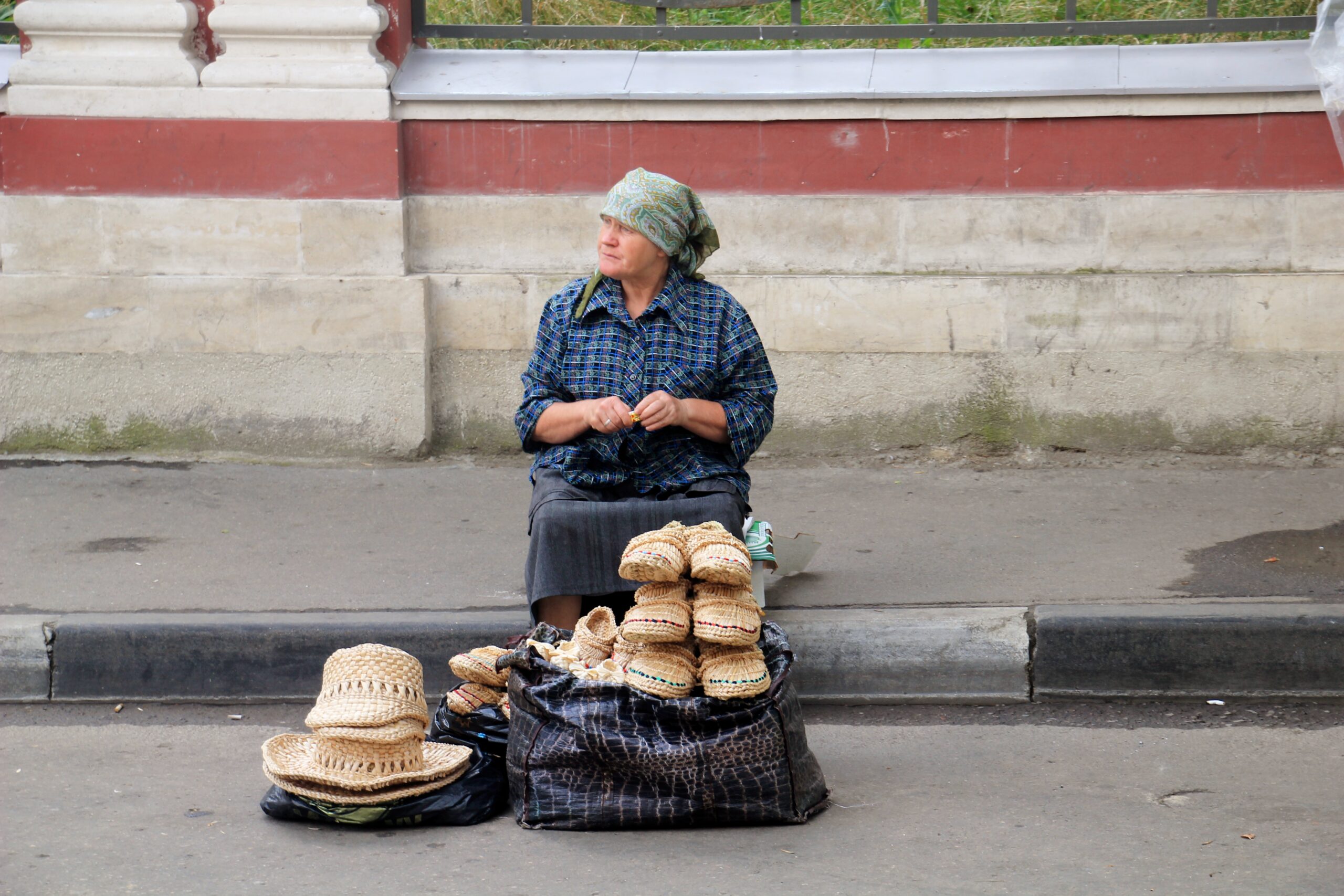 A Russian woman sells hats and shoes on a Moscow sidewalk.