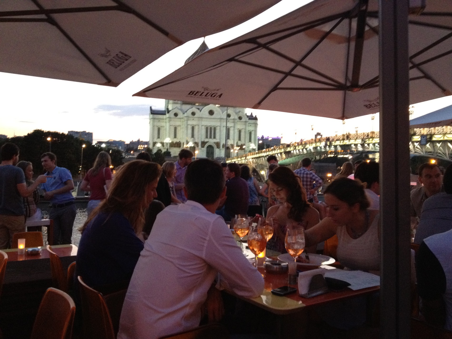 Beautiful people enjoy cocktails on the terrace of Strelka at Moscow's trendy Red October, a former chocolate factory. The Cathedral of Christ the Saviour and Patriarchiy Bridge can be seen in the distance.