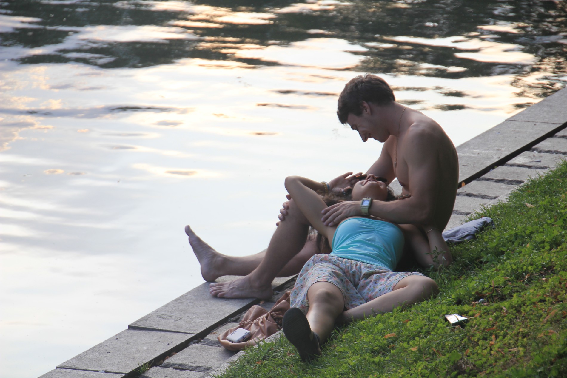 A couple enjoys dusk on the edge of Moscow's famous Patriarshiye Pond.