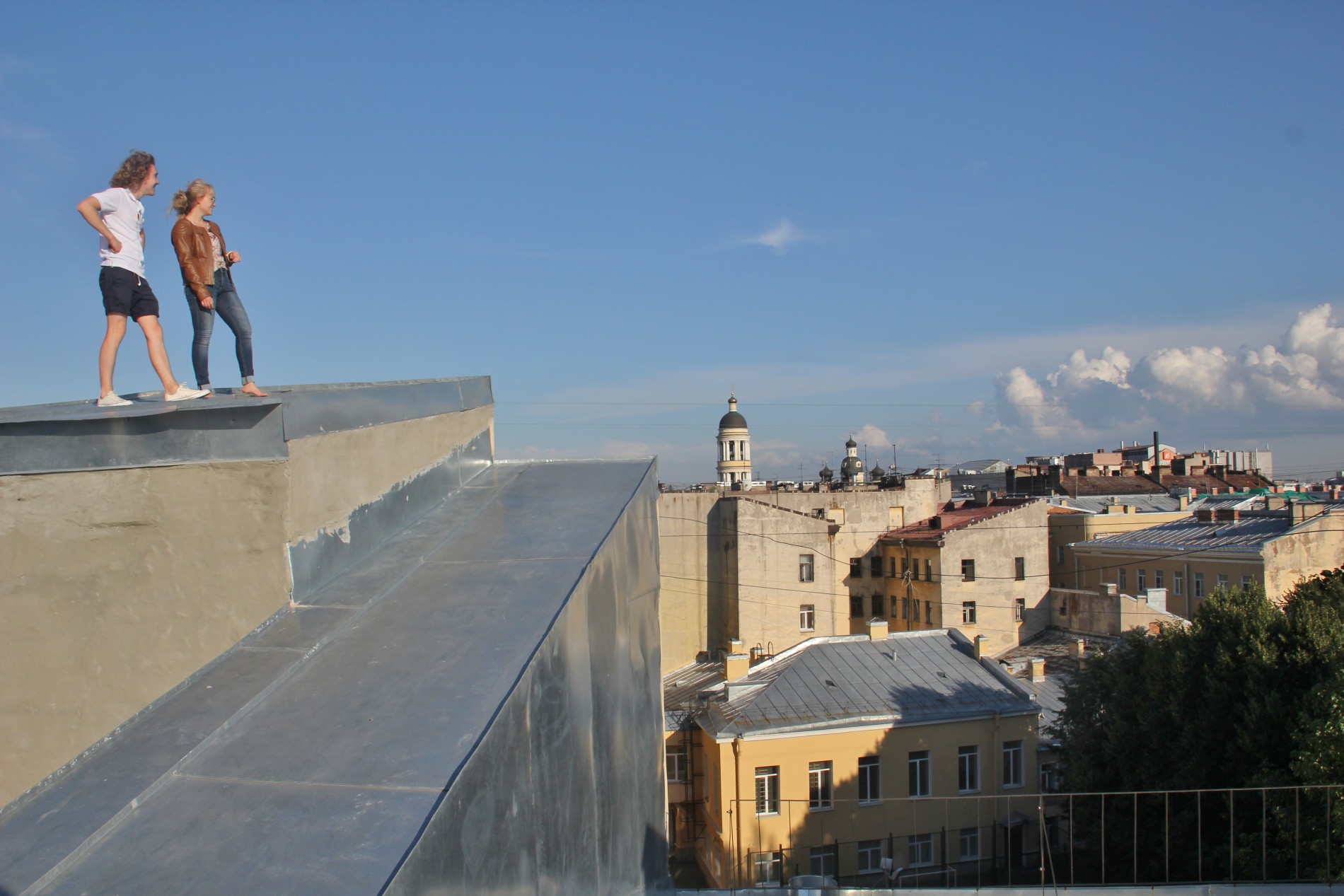 Seva and Nastya look at the view from a roof in St. Petersburg, Russia.