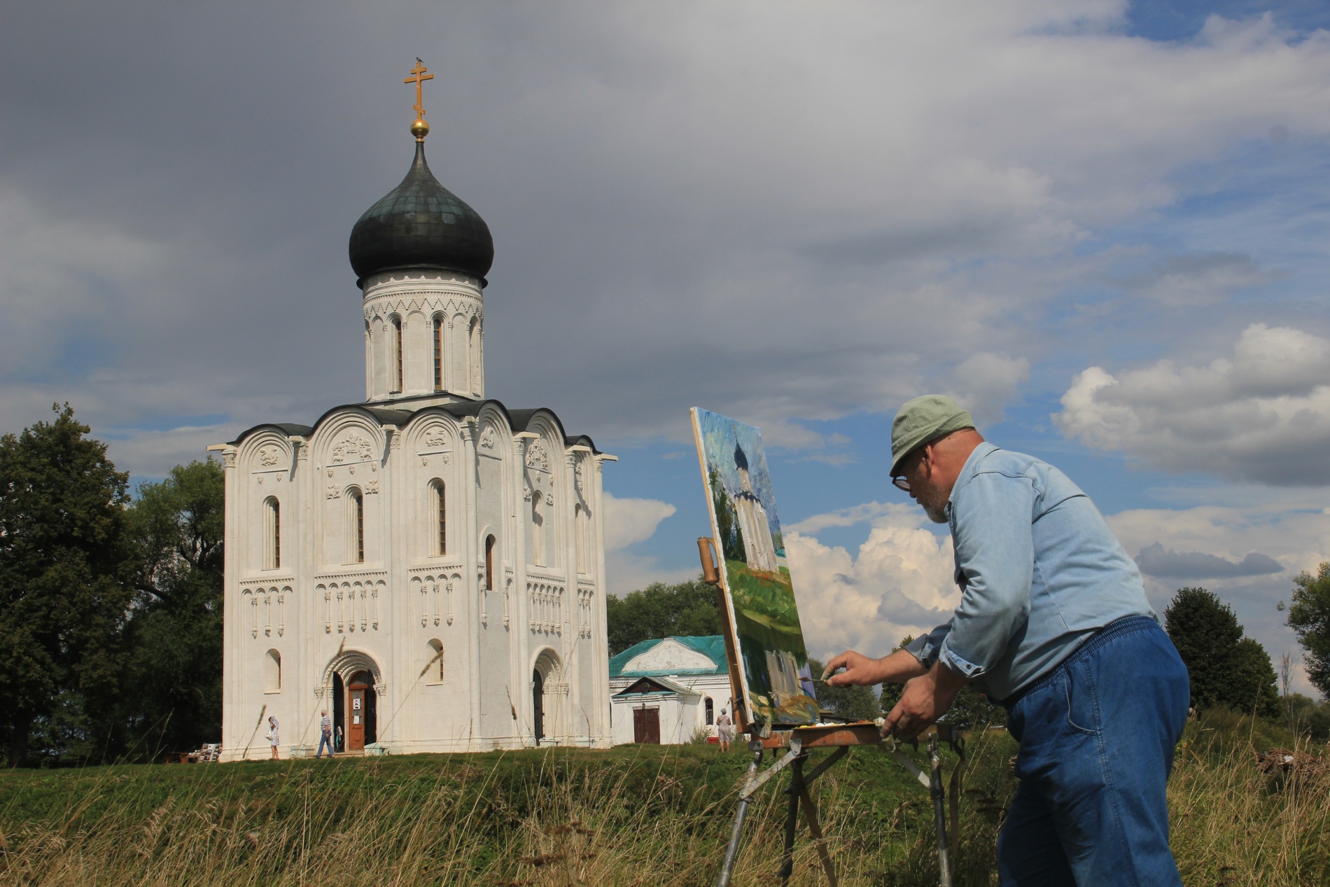 A Russian man paints the Church of the Intercession of the Holy Virgin on the Nerl River near Vladimir, Russia.