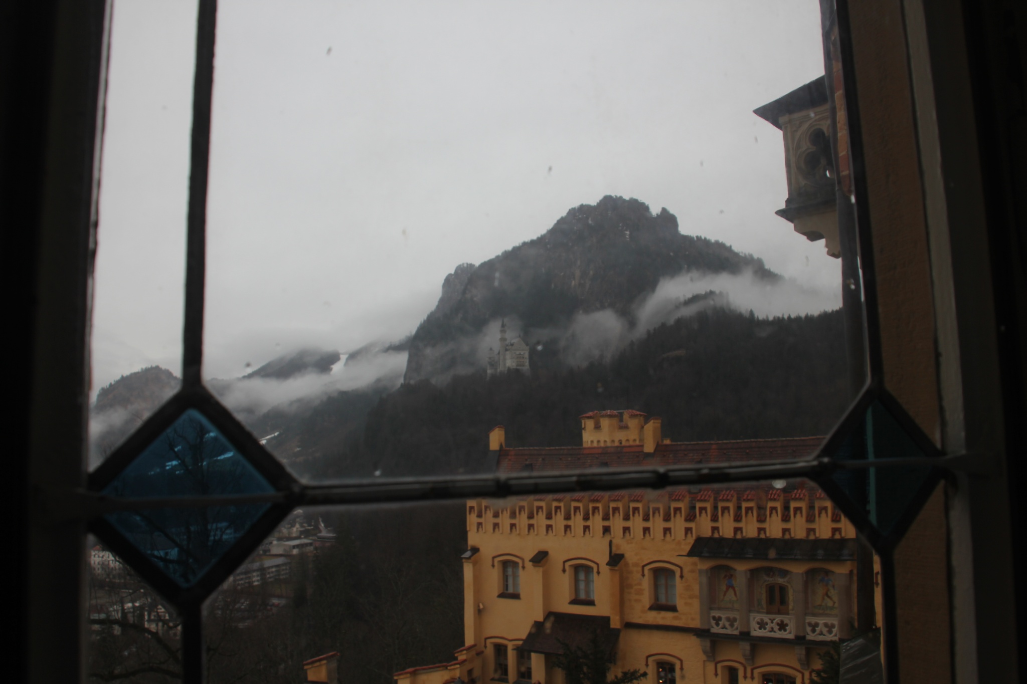 Neuschwanstein Castle can be seen through a window in Hohenschwangau Castle.