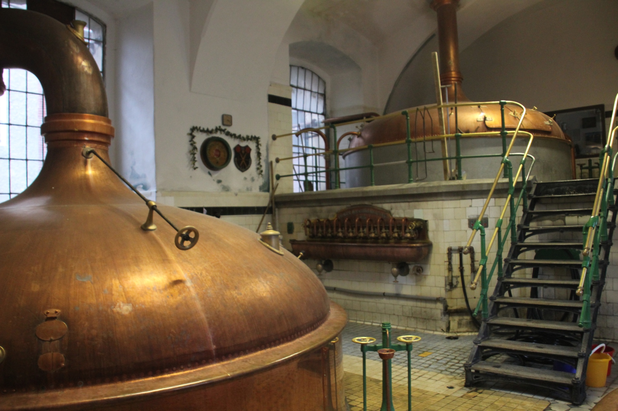 Attractive copper brew kettles sit waiting in the ancient Eggenberg Brewery in ÄŒeský Krumlov.