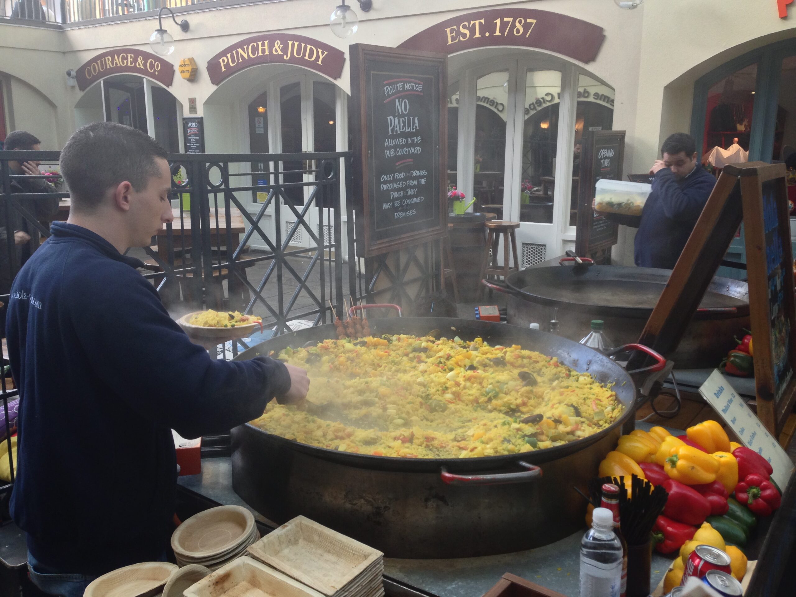 A man makes paella at Covent Garden Marker in London.