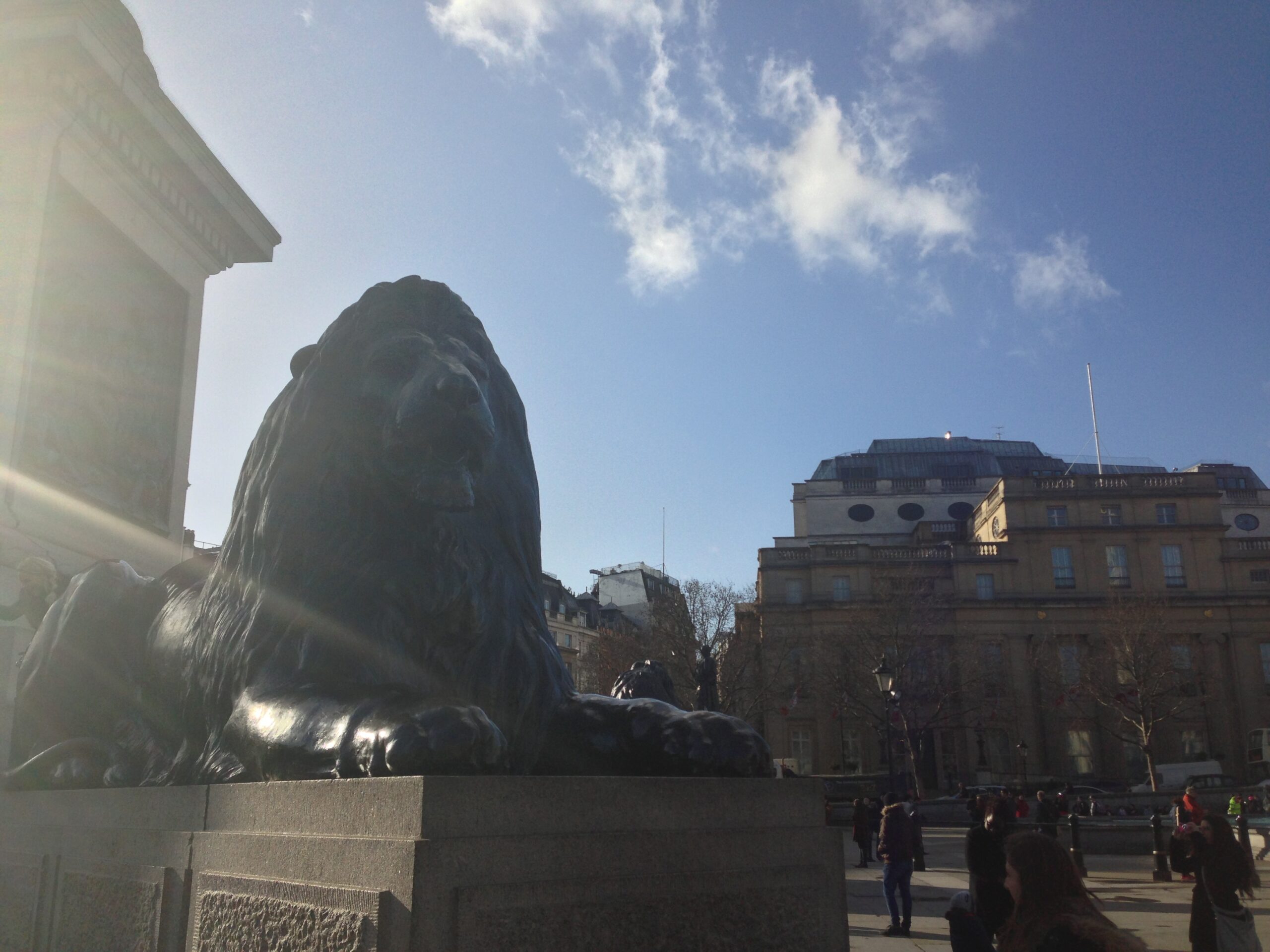 A lion statue guards war monument Nelson's Column in London's Trafalgar Square.