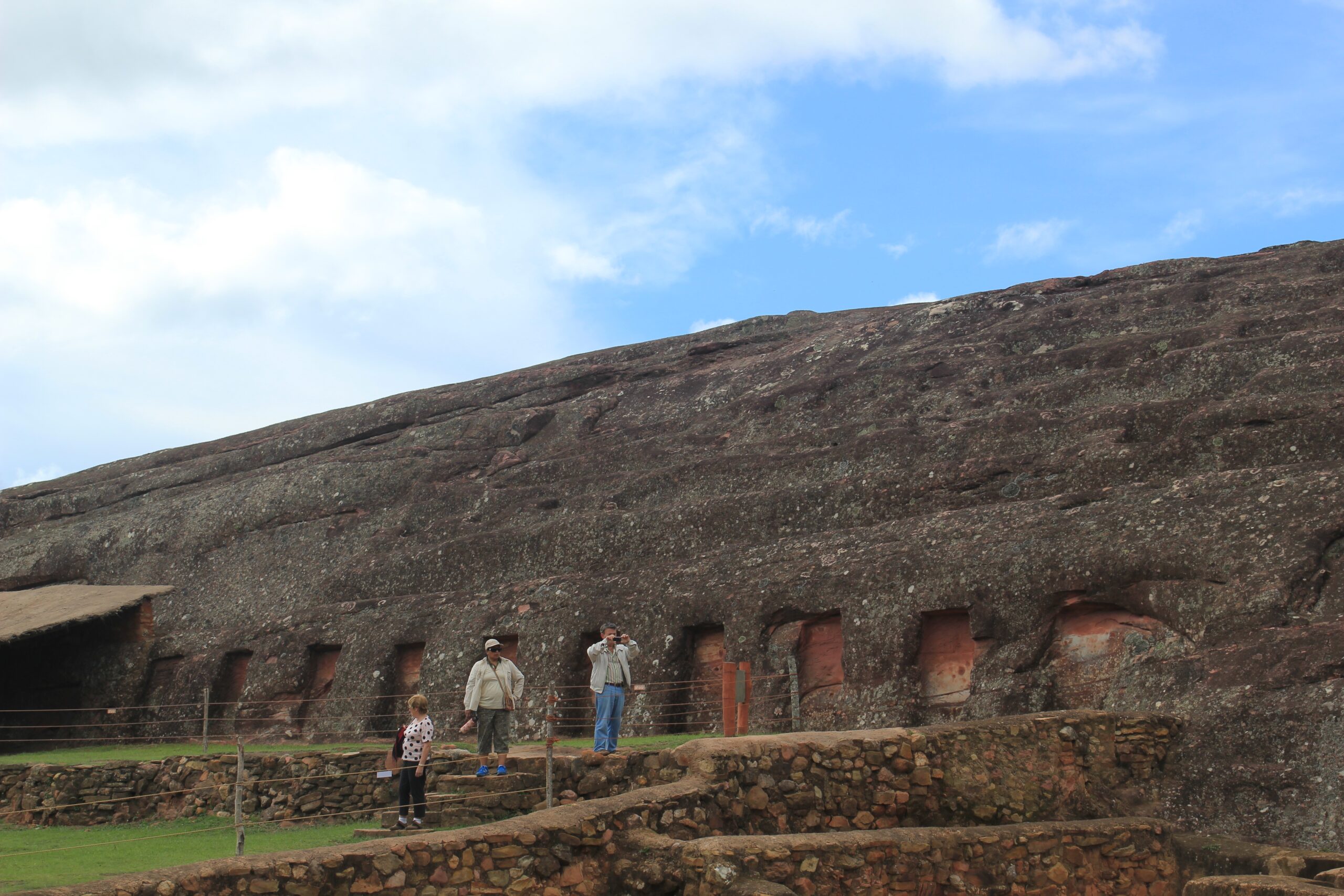 Tourists walk near the Templo de La Sacristia at the El Fuerte de Samaipata ruins in Bolivia.